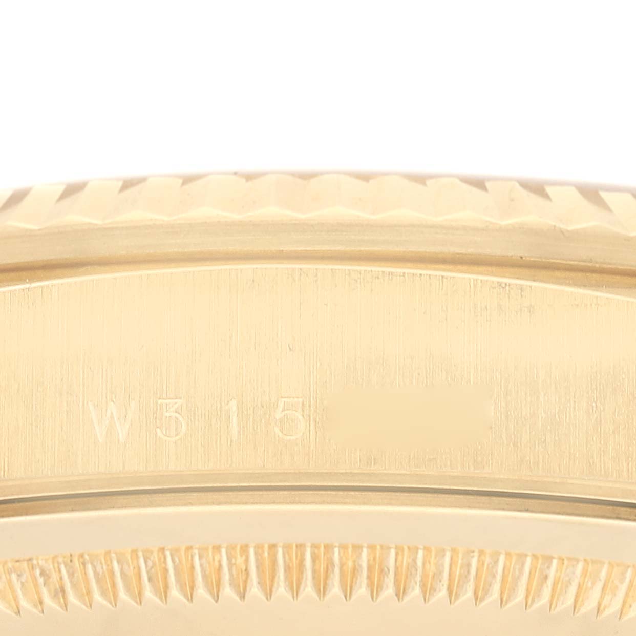 This close-up image shows the side case of a Rolex President 18238 Men's Yellow Gold Champagne Dial 18238 Men's Yellow Gold Champagne Dial model, highlighting its gold finish and serial number engraving.