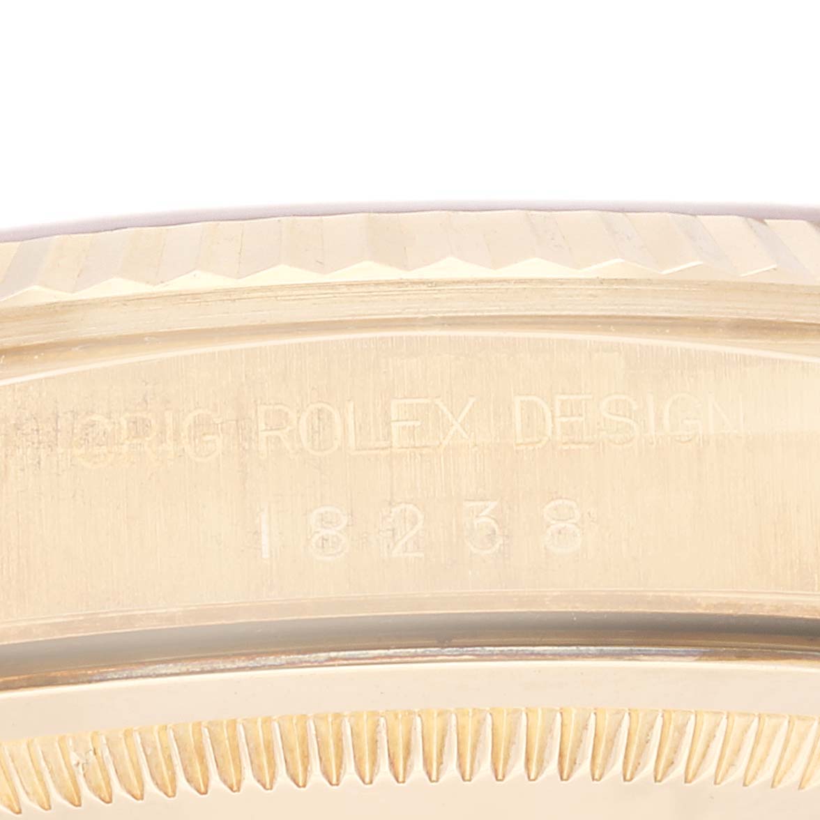 This image shows a close-up of the engraved case back and bezel of a Rolex President 18238 Men
s Yellow Gold Champagne Dial 18238 Men
s Yellow Gold Champagne Dial model.