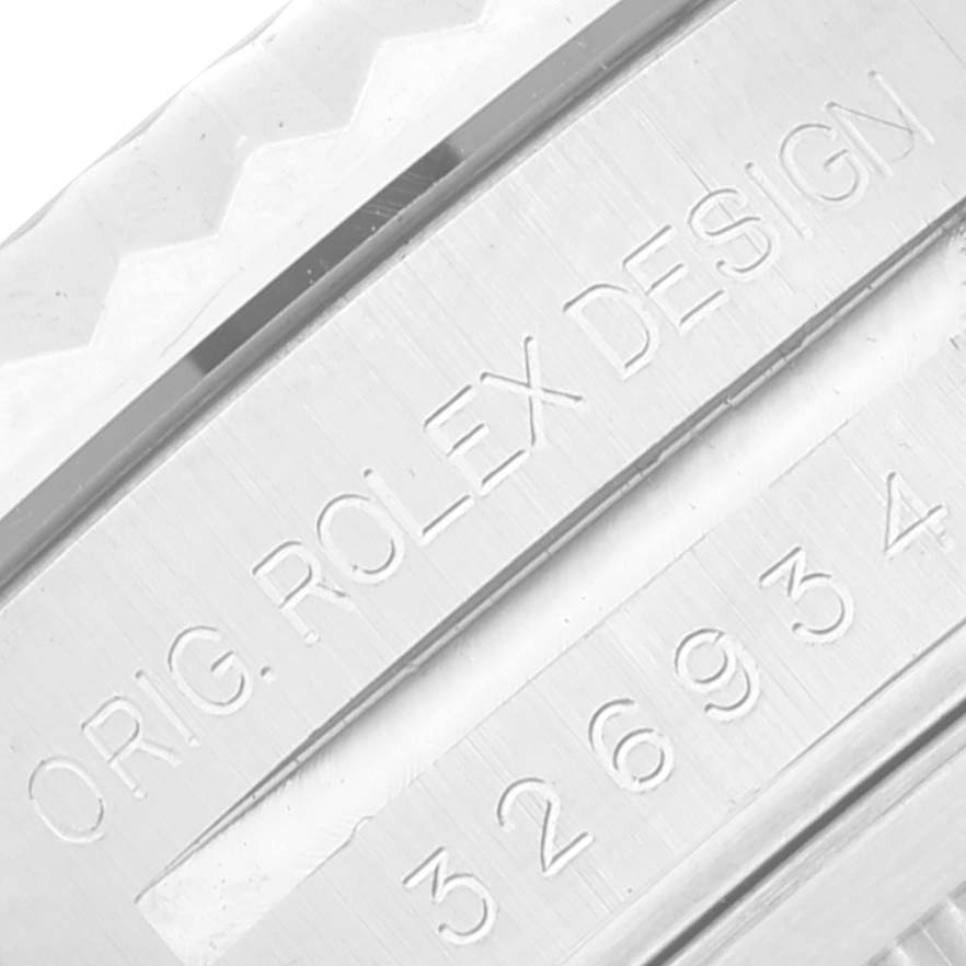 The image shows a close-up of the engraved part and serial number of a Rolex Sky-Dweller 326934 Men
s Stainless Steel Blue Dial 326934 Men
s Stainless Steel Blue Dial watch.