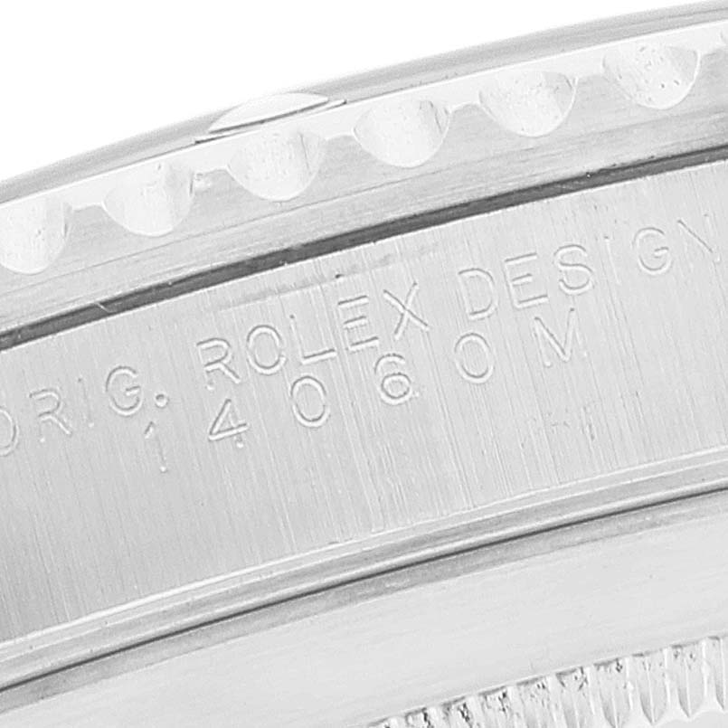 This image shows a close-up of the outer rim and engraved details on the bezel of a Rolex Submariner 14060 Men
s Stainless Steel Black Dial 14060 Men
s Stainless Steel Black Dial model.