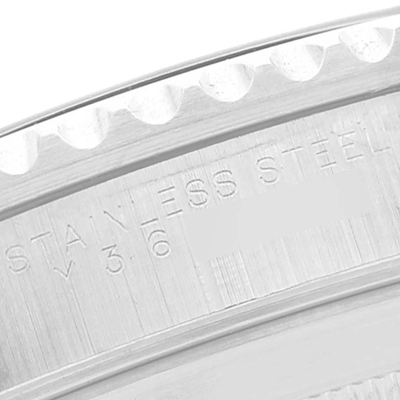 The image shows a close-up of the Rolex Submariner 14060 Men
s Stainless Steel Black Dial 14060 Men
s Stainless Steel Black Dial
s stainless steel case back edge with part of the model inscription.