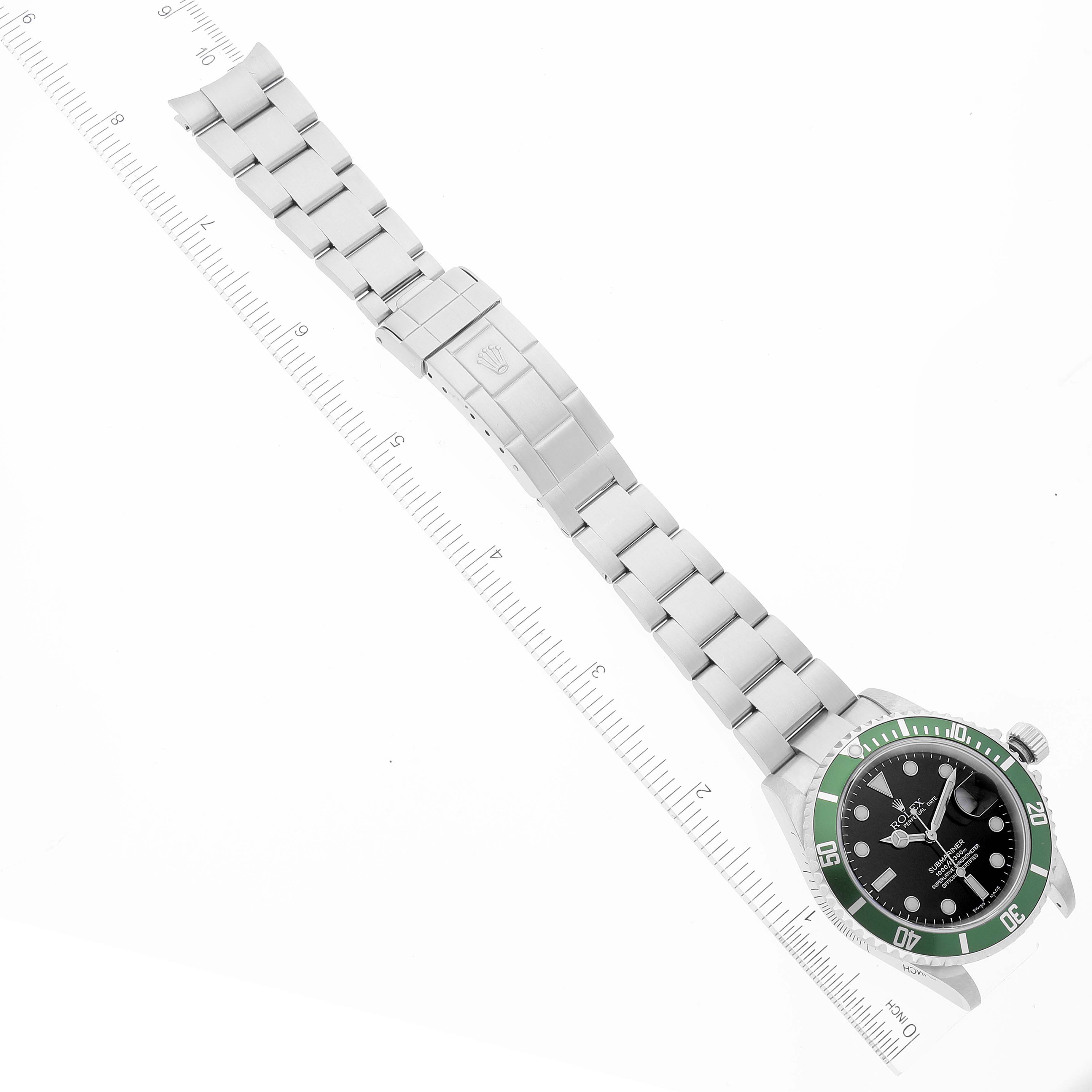 The image shows a Rolex Submariner 16610LV Men
s Stainless Steel Black Dial 16610LV Men
s Stainless Steel Black Dial watch laid flat, highlighting the bracelet, clasp, and watch face with a green bezel.