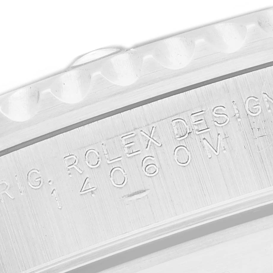 The image shows a close-up angle of the engraved case back edge of the Rolex Submariner, model number 14060.