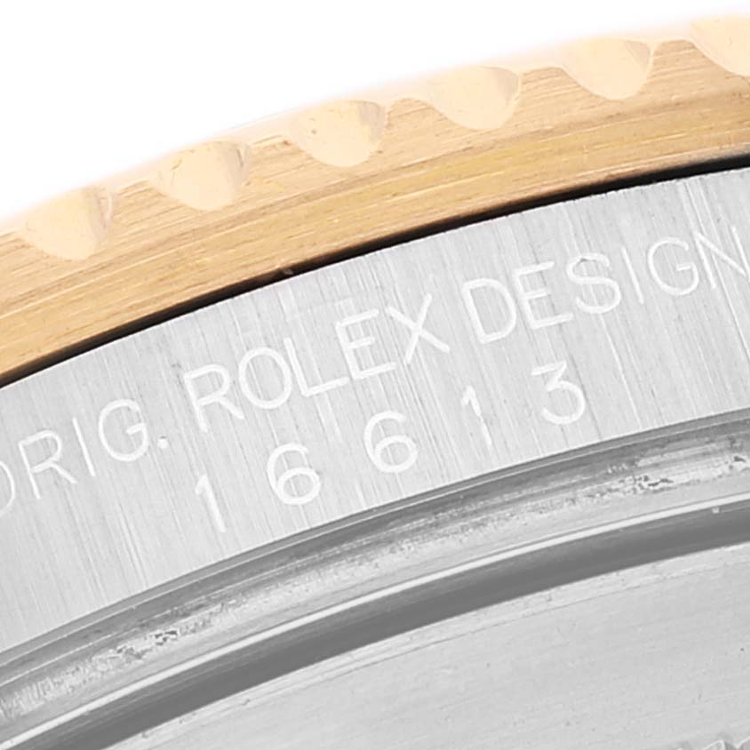 The image shows a close-up of the case back and bezel edge of a Rolex Submariner 16613 Men's Steel and Gold (two tone) Grey Dial 16613 Men's Steel and Gold (two tone) Grey Dial, including the engraved model number 16613.