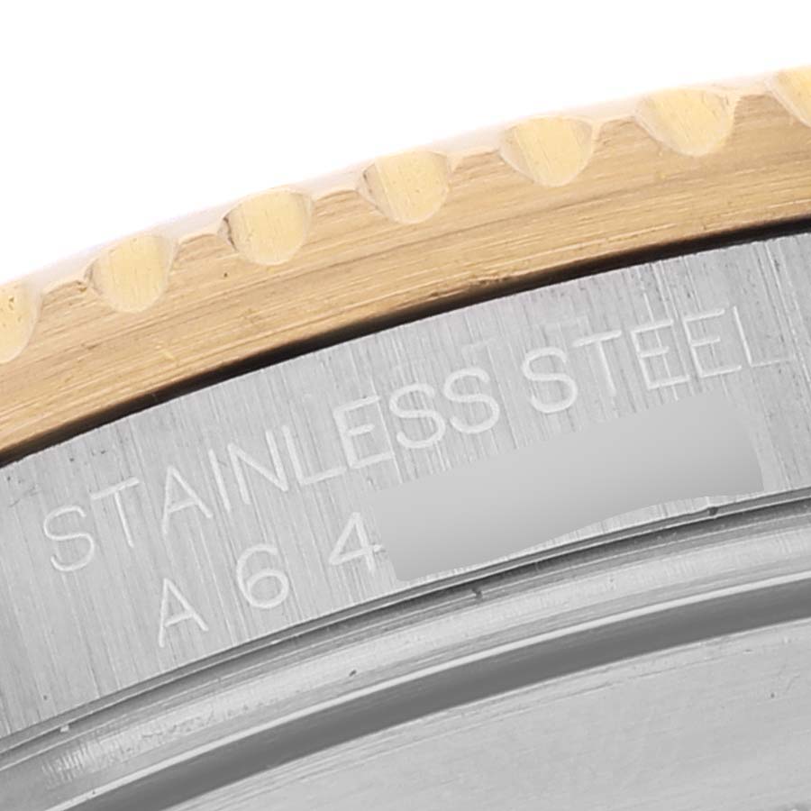This close-up image shows the bezel and caseback edge of a Rolex Submariner 16613 Men's Steel and Gold (two tone) Grey Dial 16613 Men's Steel and Gold (two tone) Grey Dial watch, highlighting the "stainless steel" engraving.