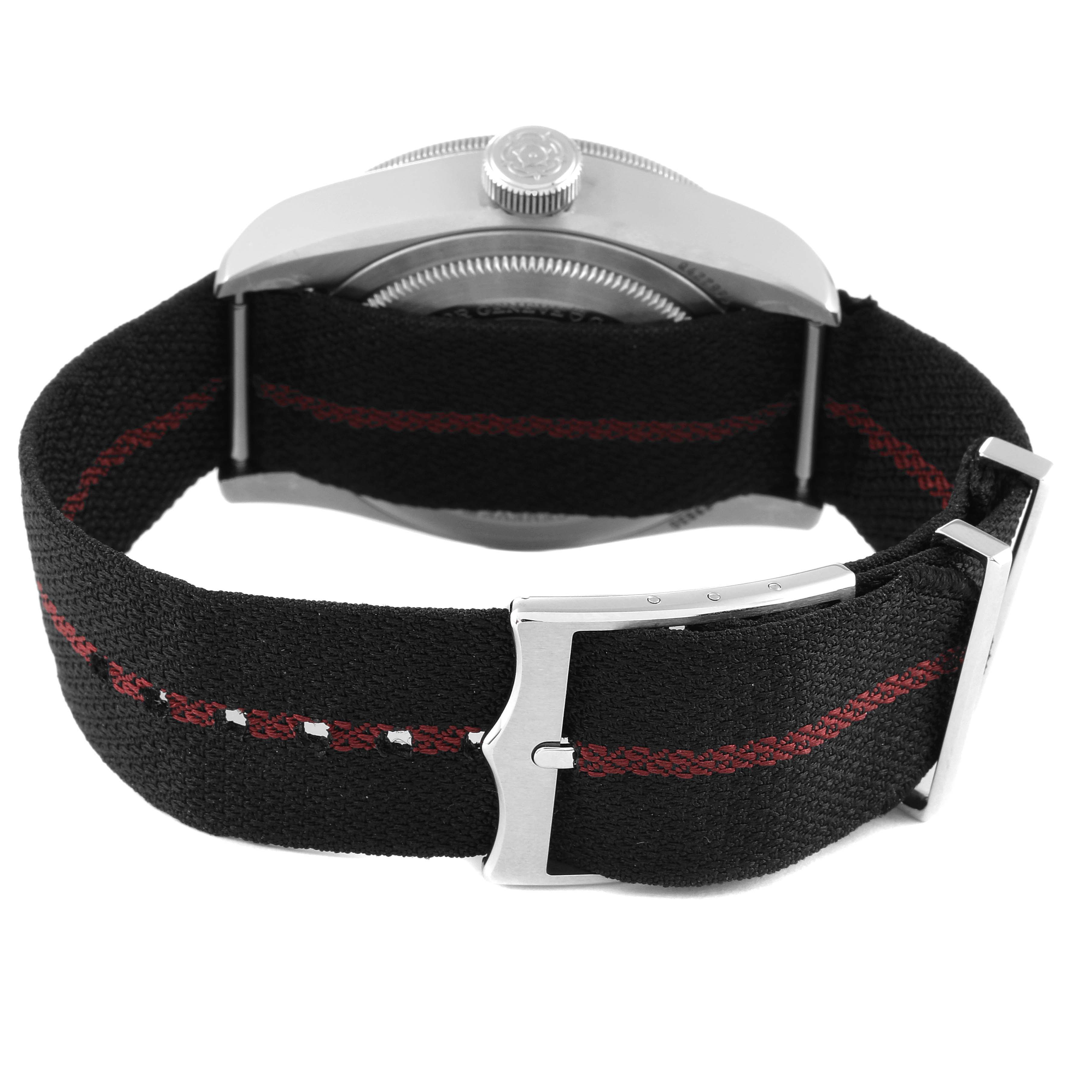 The image shows the back view of a Tudor Heritage Black Bay 79830RB Men's Stainless Steel Black Dial 79830RB Men's Stainless Steel Black Dial watch, focusing on the fabric strap and clasp.