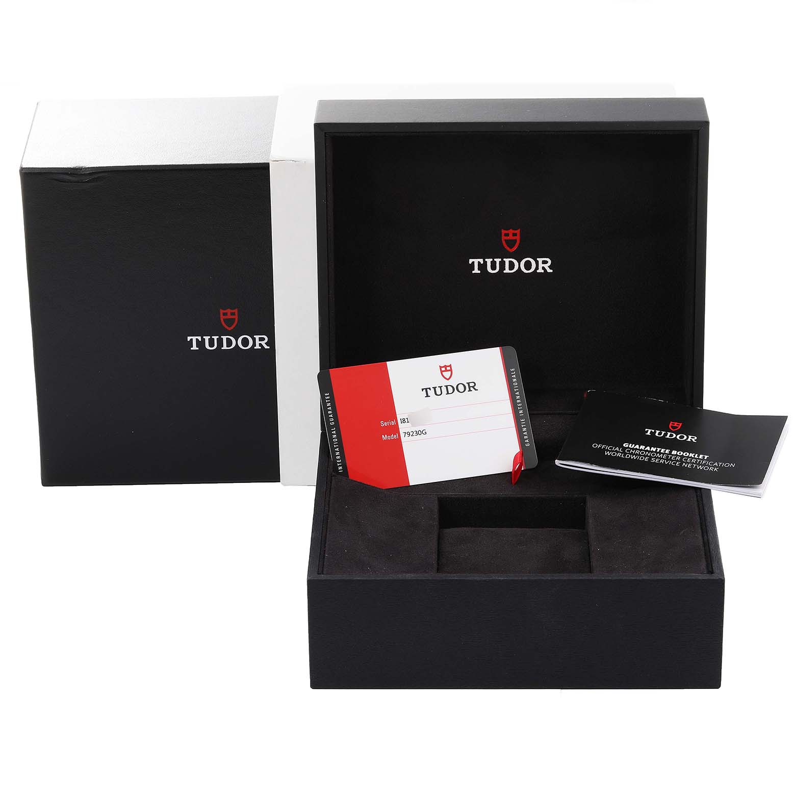 This image shows the packaging, warranty card, and booklet for the Tudor Heritage Black Bay 79230G Men's Stainless Steel Black Dial 79230G Men's Stainless Steel Black Dial watch.