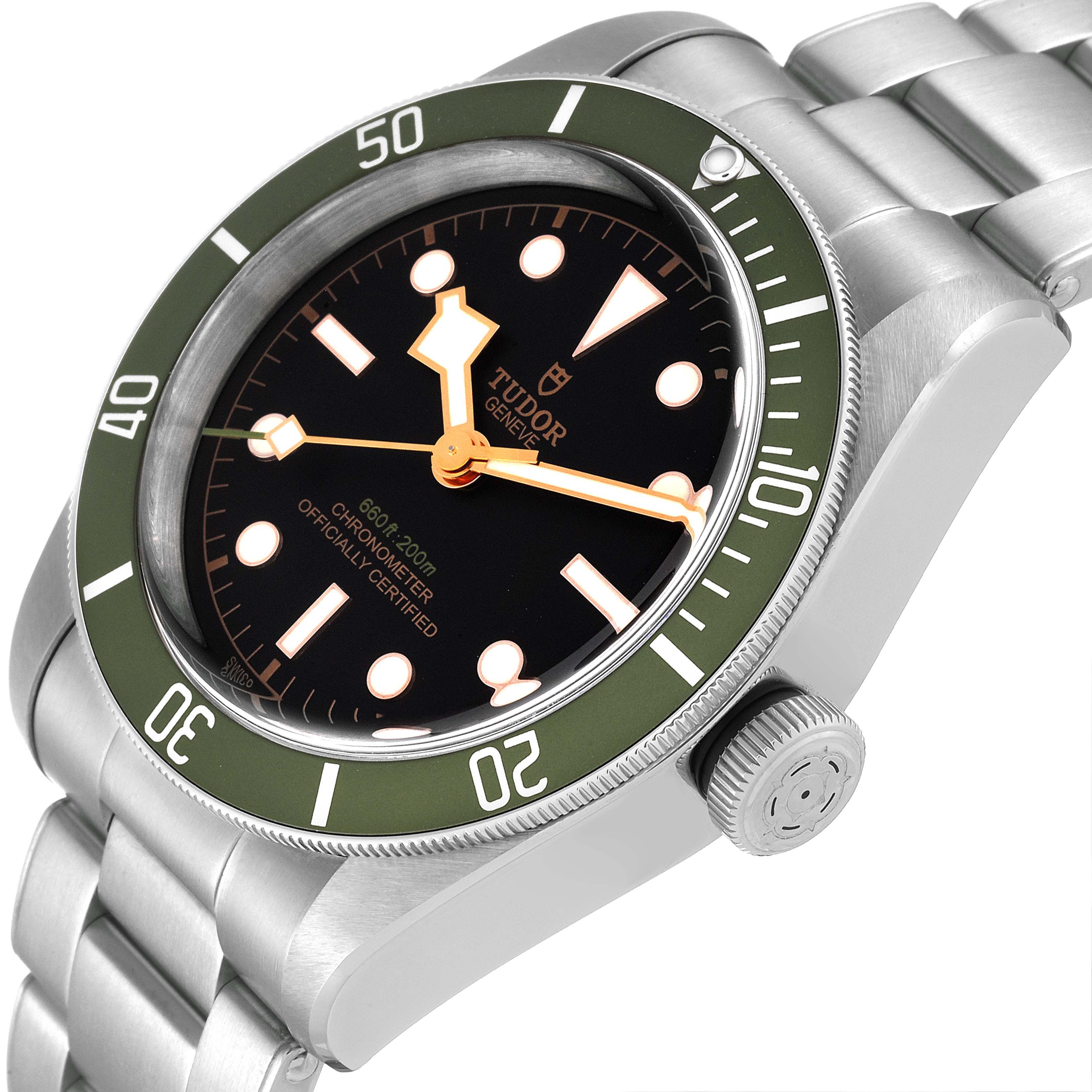 The Tudor Heritage Black Bay 79230G Men's Stainless Steel Black Dial 79230G Men's Stainless Steel Black Dial watch is shown at an angle highlighting the face, bezel, crown, and part of the bracelet.