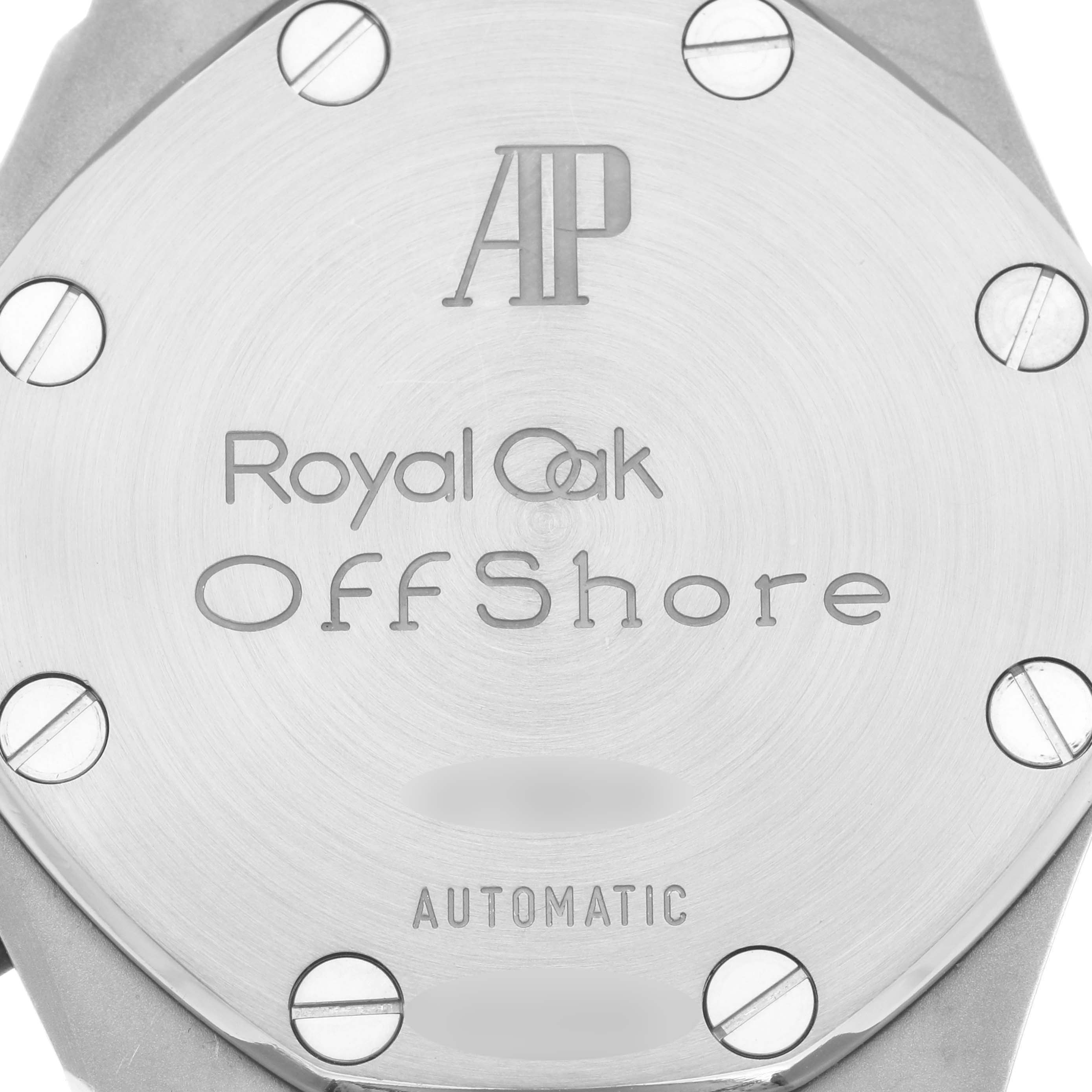 The image shows the back case of an Audemars Piguet Royal Oak Offshore 25770ST.OO.D009XX.02 Men's Stainless Steel Yellow Dial 25770ST.OO.D009XX.02 Men's Stainless Steel Yellow Dial watch, featuring screws and engraving.