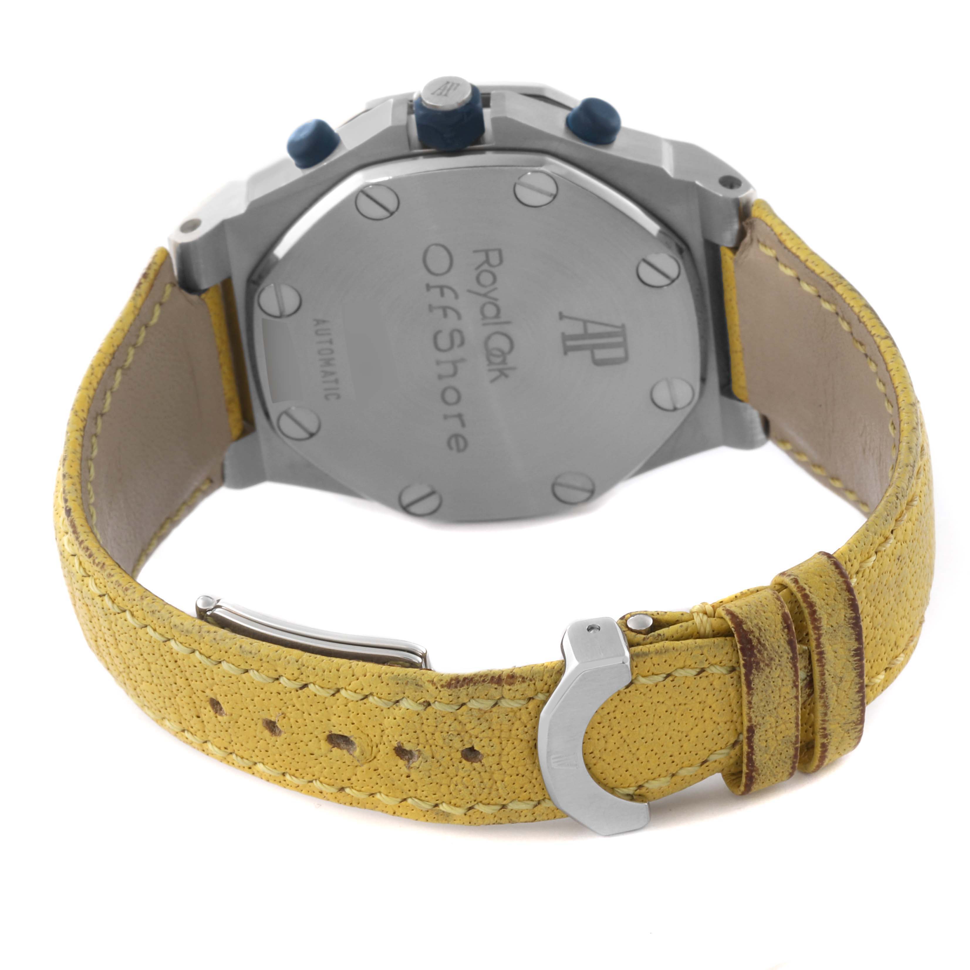 The image shows the back case and strap of the Royal Oak Offshore model by Audemars Piguet, highlighting the engraving and yellow leather strap.