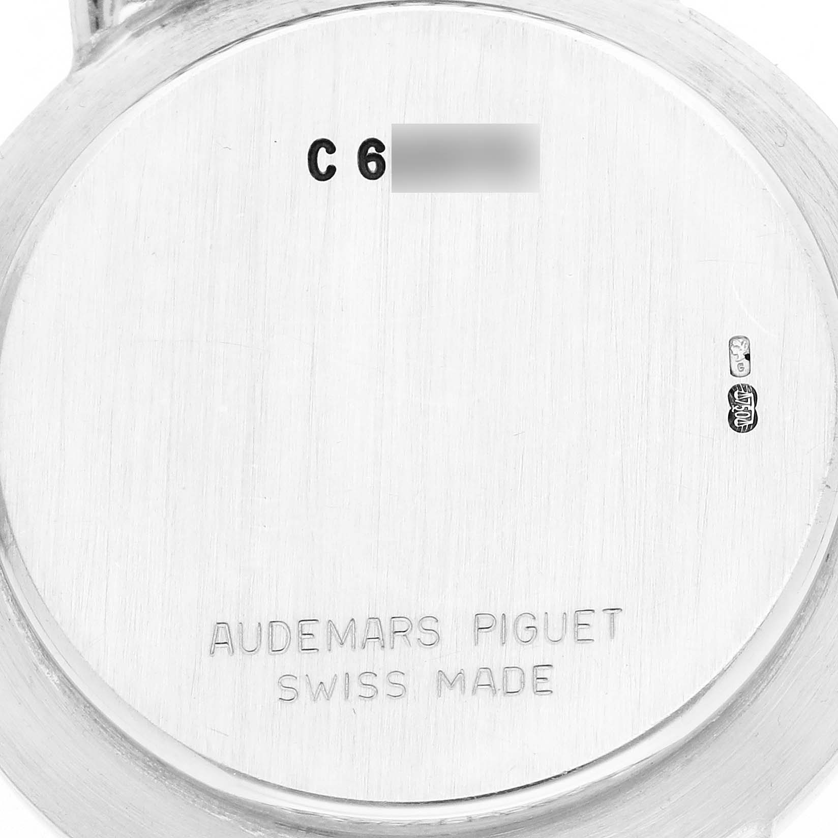 The image shows the back case of an Audemars Piguet Vintage Round White Gold Diamond Sapphire Ladies Watch, displaying its engraved branding and Swiss Made mark.