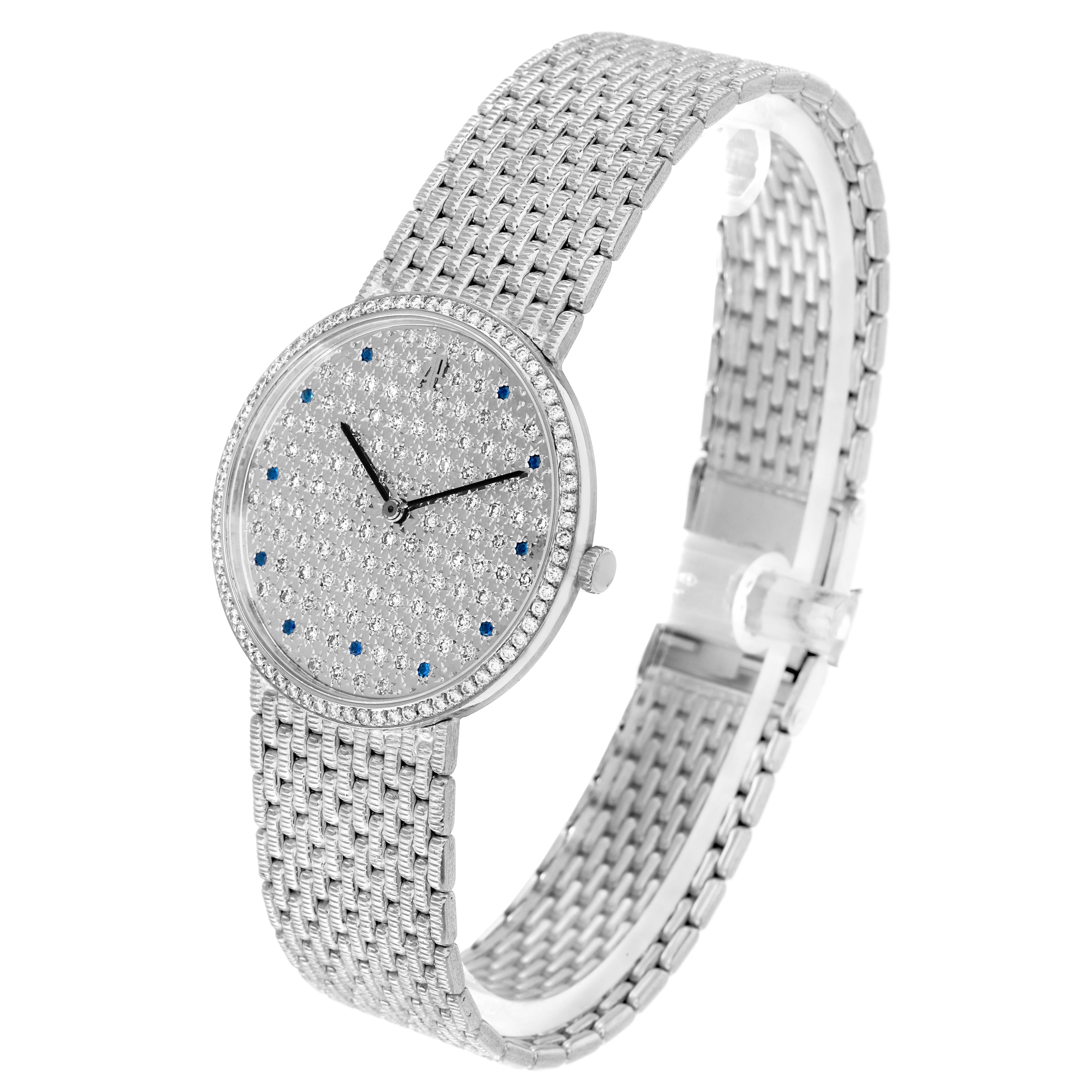 The Audemars Piguet Vintage Round White Gold Diamond Sapphire Ladies Watch is shown at a three-quarter angle, highlighting its diamond-encrusted face and woven bracelet.