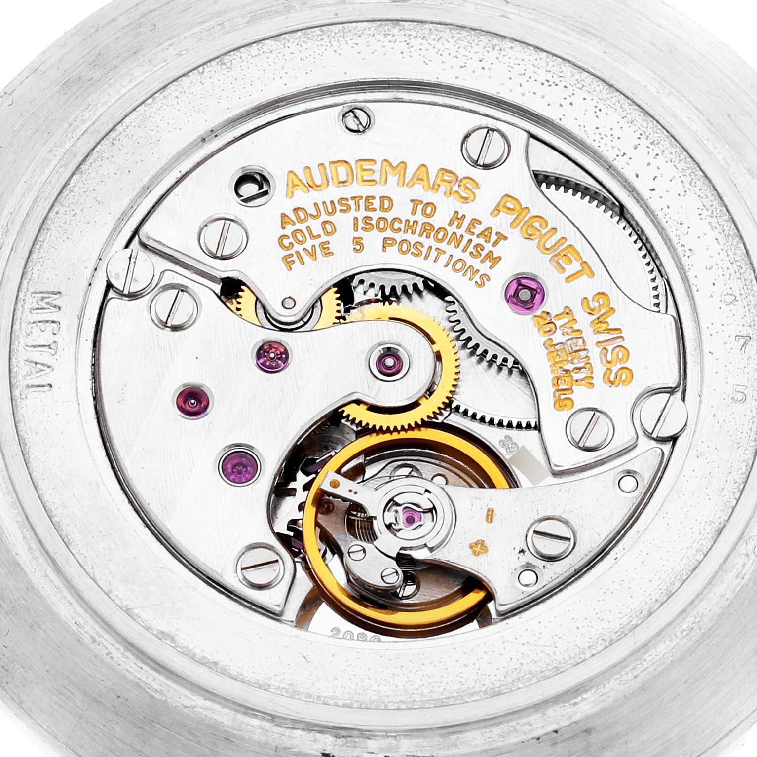 The image shows the internal mechanism of the Audemars Piguet Vintage Round White Gold Diamond Sapphire Ladies Watch, featuring gears and inscriptions.