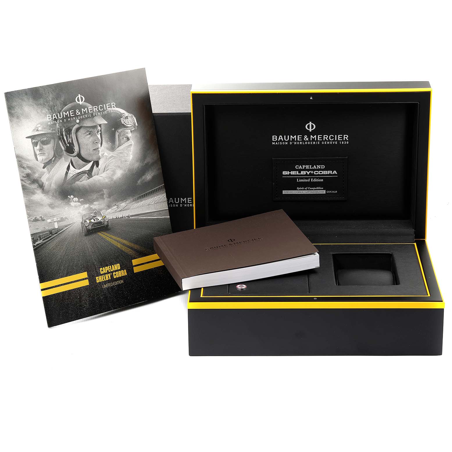 The image shows the open packaging box, booklet, and a pamphlet for the Baume & Mercier Capeland 65798 Men's Stainless Steel Black Dial 65798 Men's Stainless Steel Black Dial model watch.