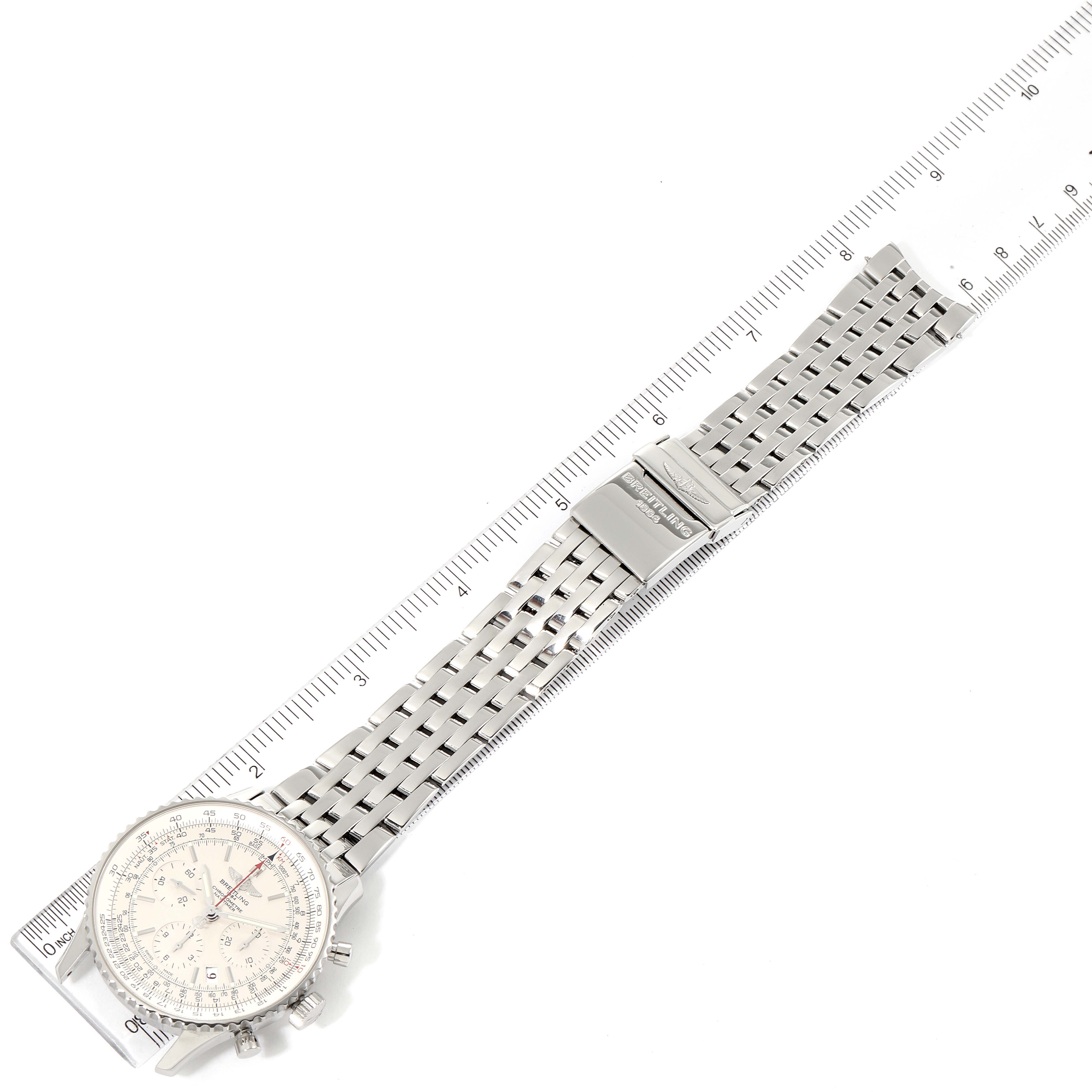 The Breitling Navitimer AB0123 Men's Stainless Steel Silver Dial AB0123 Men's Stainless Steel Silver Dial watch is shown laid flat with its bracelet extended, positioned alongside a ruler for scale.