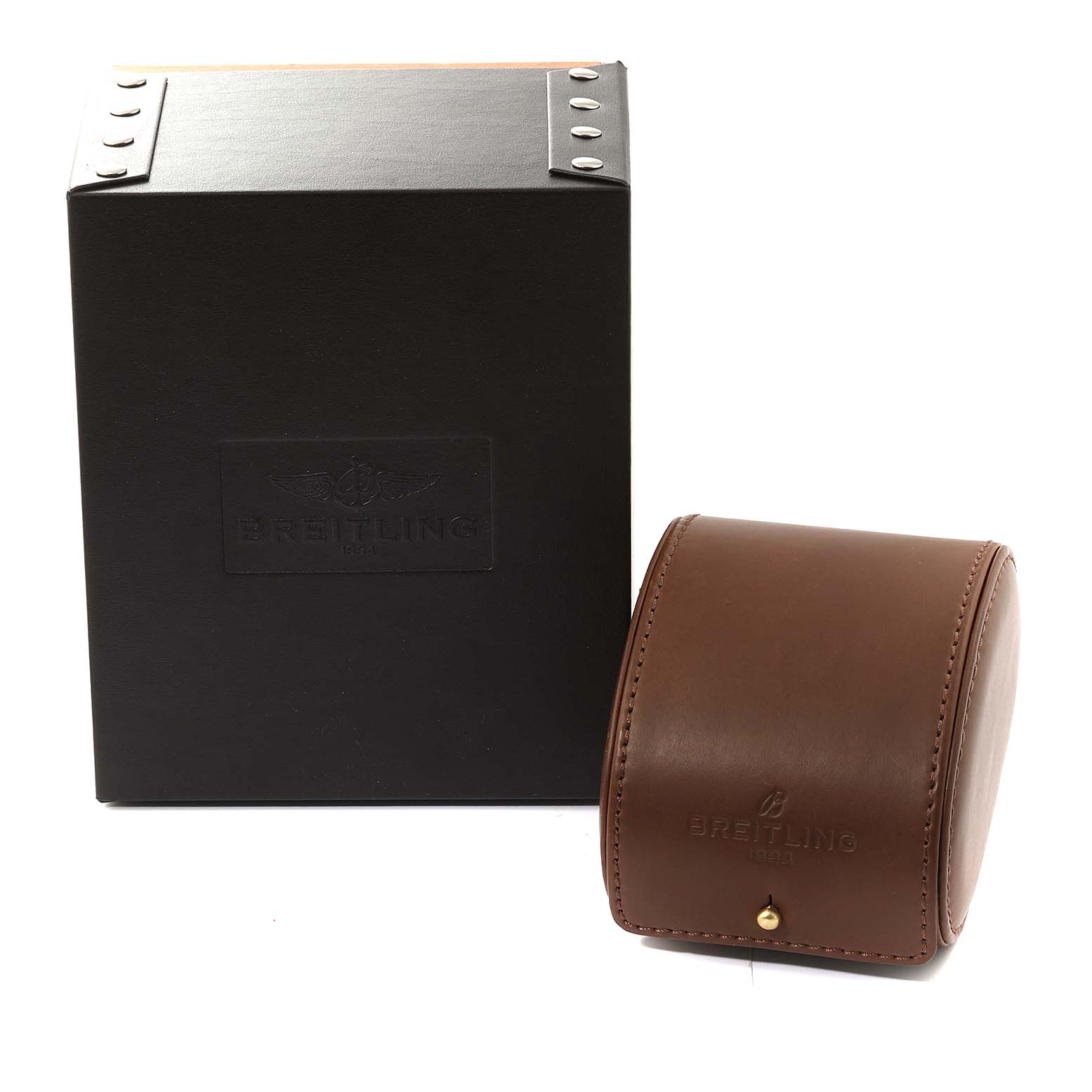 The image shows the Breitling Navitimer RB0120 Men's Rose Gold Black Dial RB0120 Men's Rose Gold Black Dial's black box and brown leather watch case, both positioned at a slight angle.