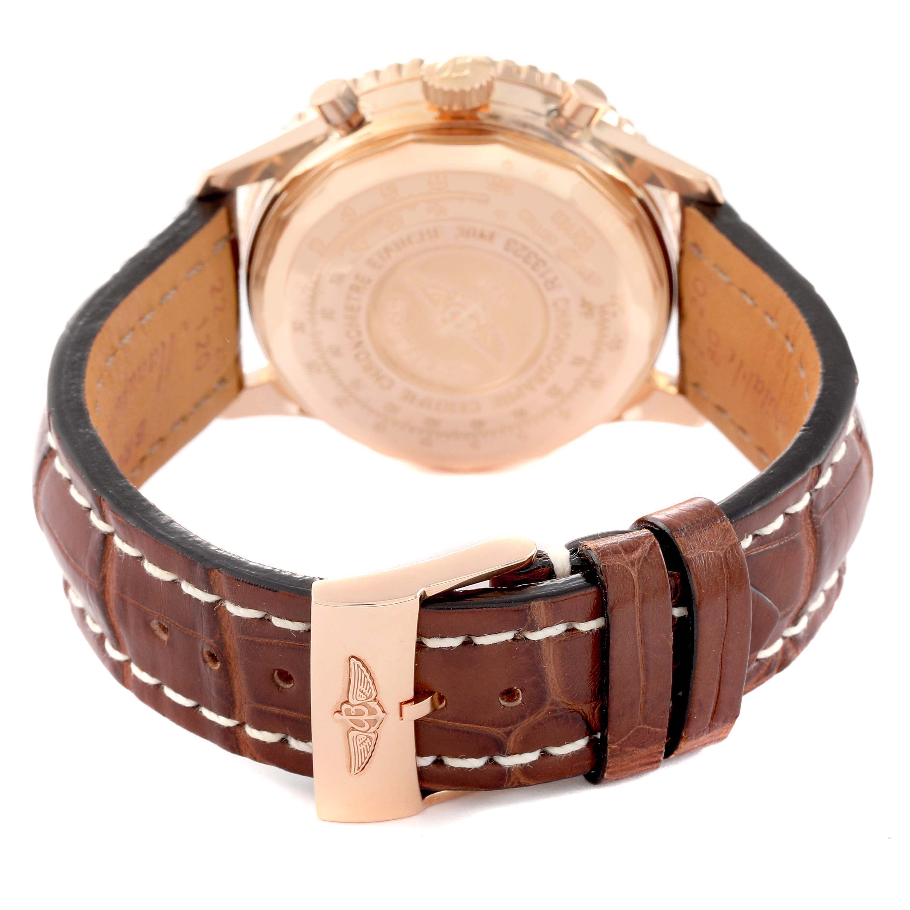 The image shows the back view of a Breitling Navitimer, model R13323, highlighting the case back, leather strap, and clasp.