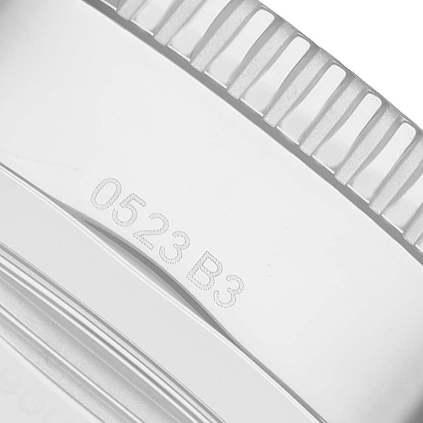 The image shows a close-up of the ridged bezel and engraved number on the Breitling Superocean AB2020121L1S1 Men's Stainless Steel Green Dial watch.