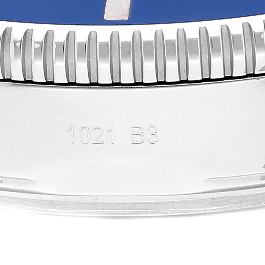 The image shows a close-up of the bezel and part of the case side of a Breitling Superocean AB2010 Men's Stainless Steel Blue Dial AB2010 Men's Stainless Steel Blue Dial watch with the engraving "1021 B3."