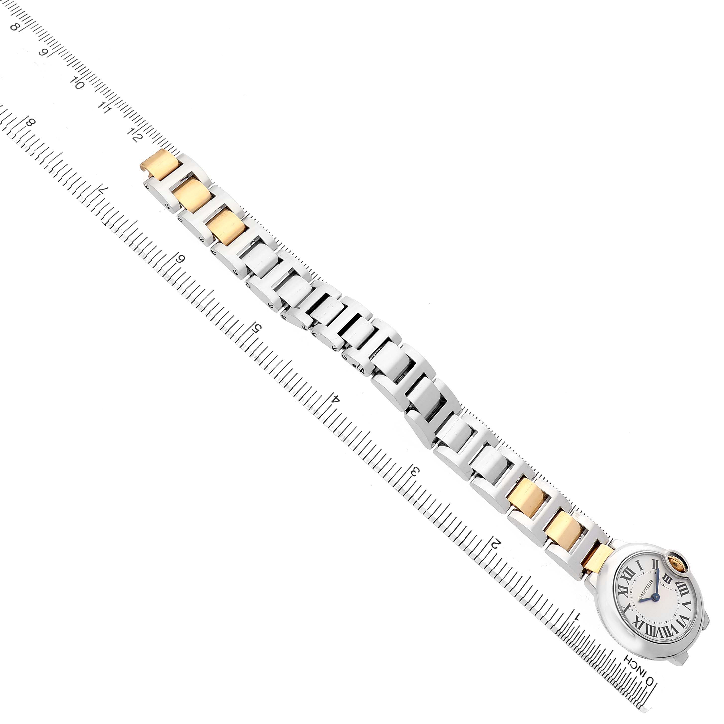 The Cartier Ballon Bleu W69007Z3 Women's Stainless Steel Silver Dial watch is shown from a top view, displaying its bracelet and face, aligned along a ruler.