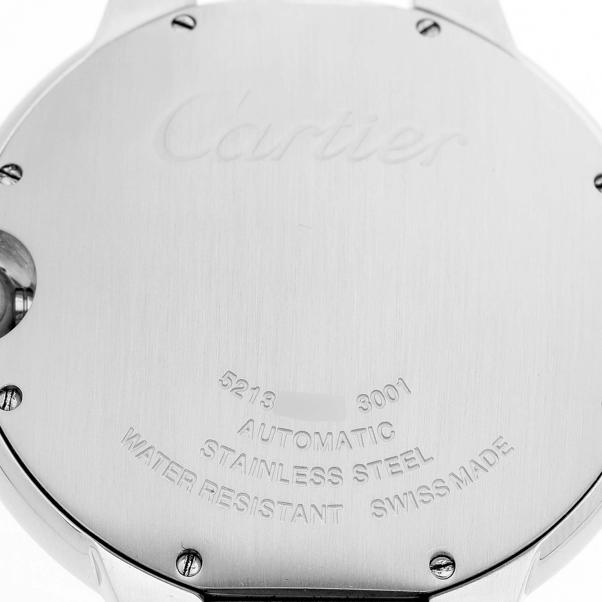 The image shows the case back of the Cartier Ballon Bleu W69012Z4 Men's Stainless Steel Silver Dial watch, displaying engraved details and screws.