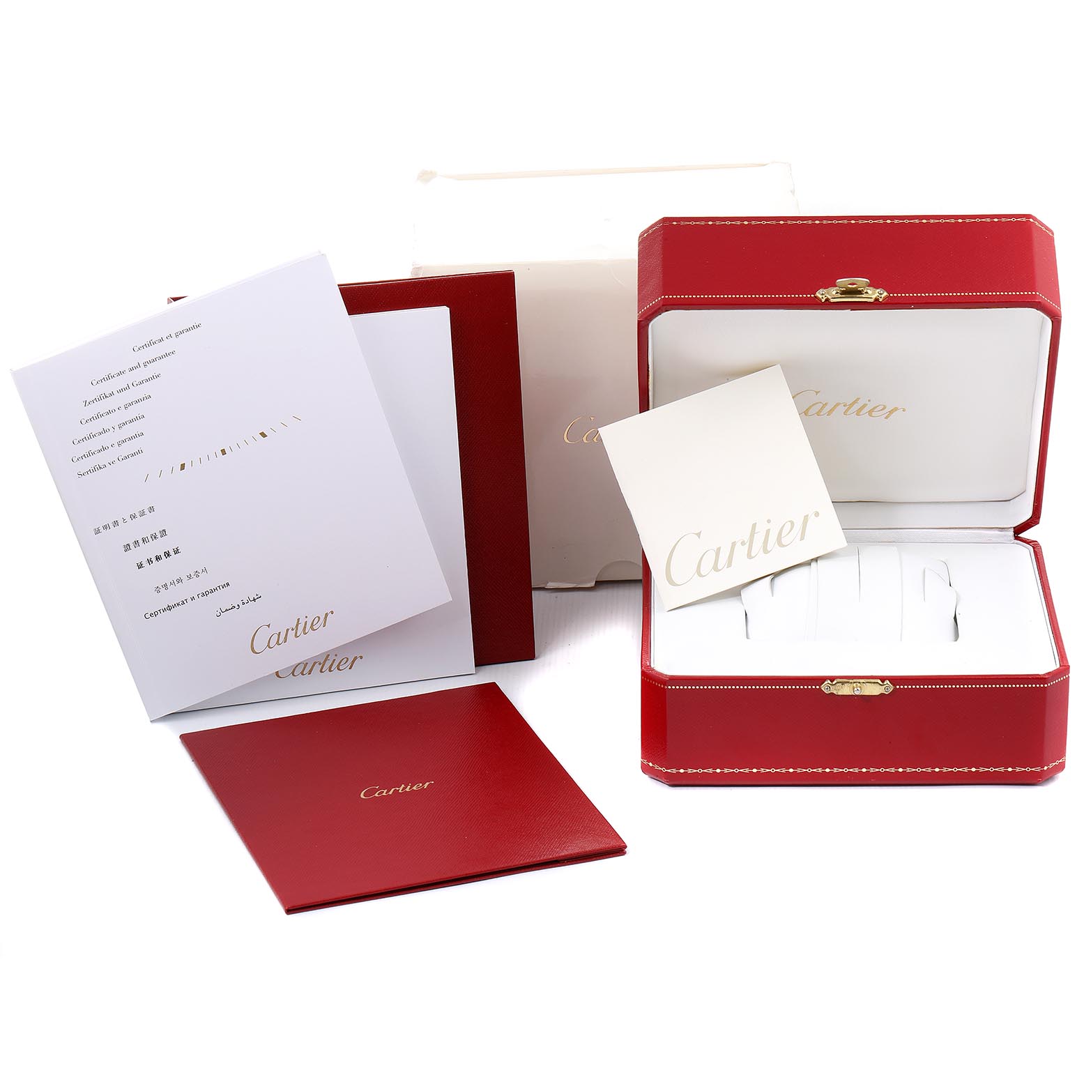 The image shows the box and documentation for the Calibre de Cartier model by Cartier, including a red case, certificates, and manuals.