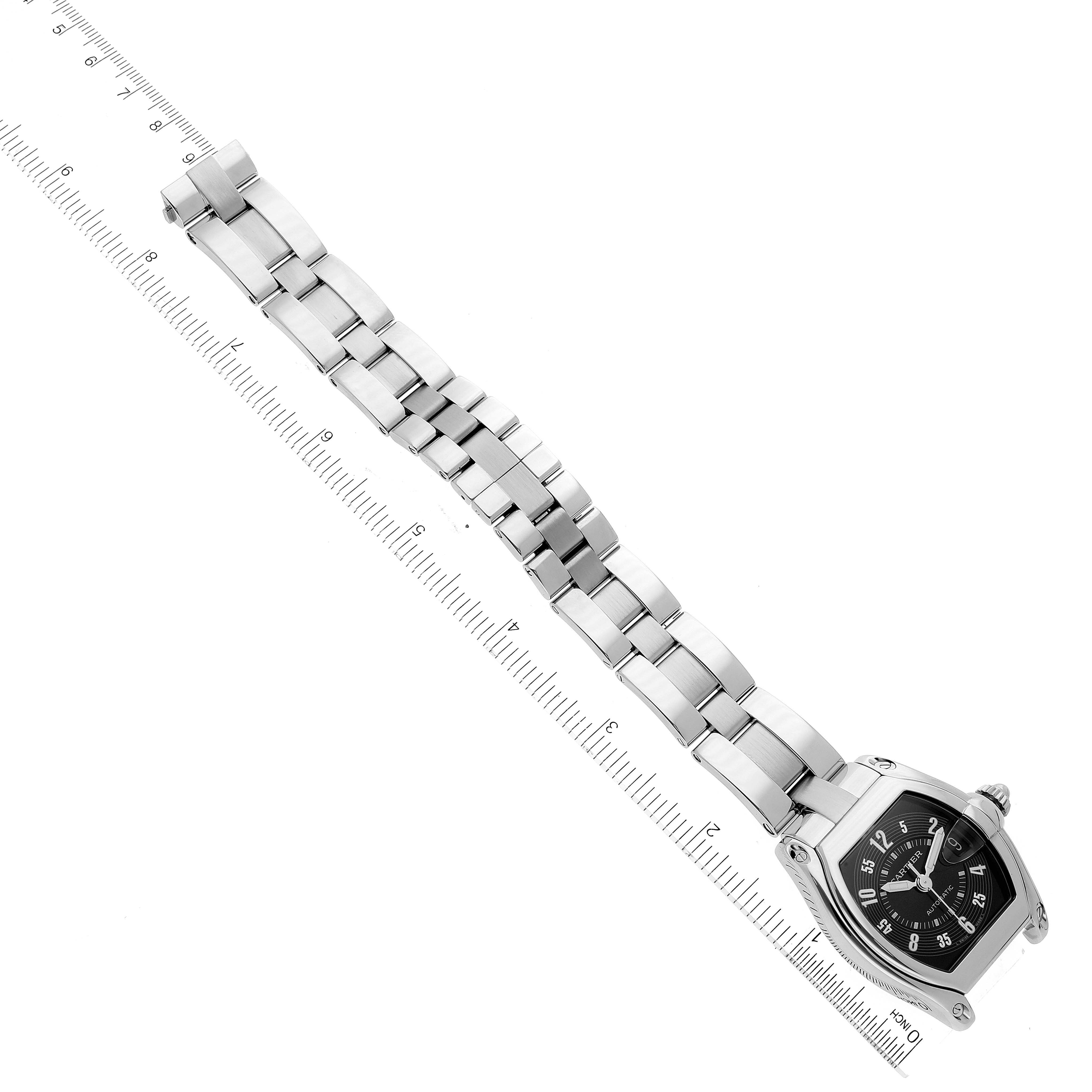 The Cartier Roadster W62004V3 Men's Stainless Steel Black Dial W62004V3 Men's Stainless Steel Black Dial watch is shown at an angled top-down view, displaying its face and entire metal bracelet against a ruler for scale.