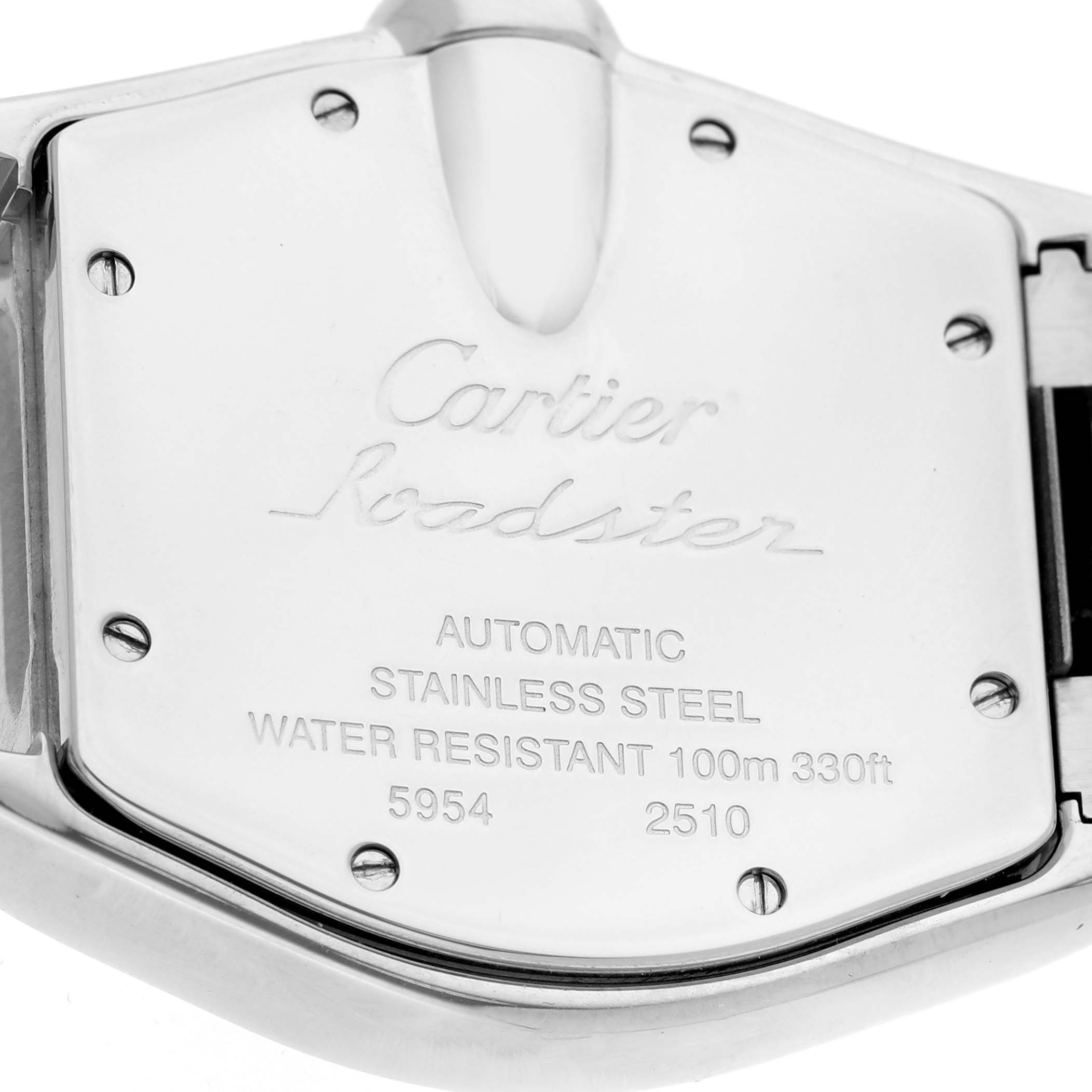 The image shows the back case of a Cartier Roadster W62048V3 Men's Stainless Steel Blue Dial watch, featuring engravings and screws, in a close-up angle.