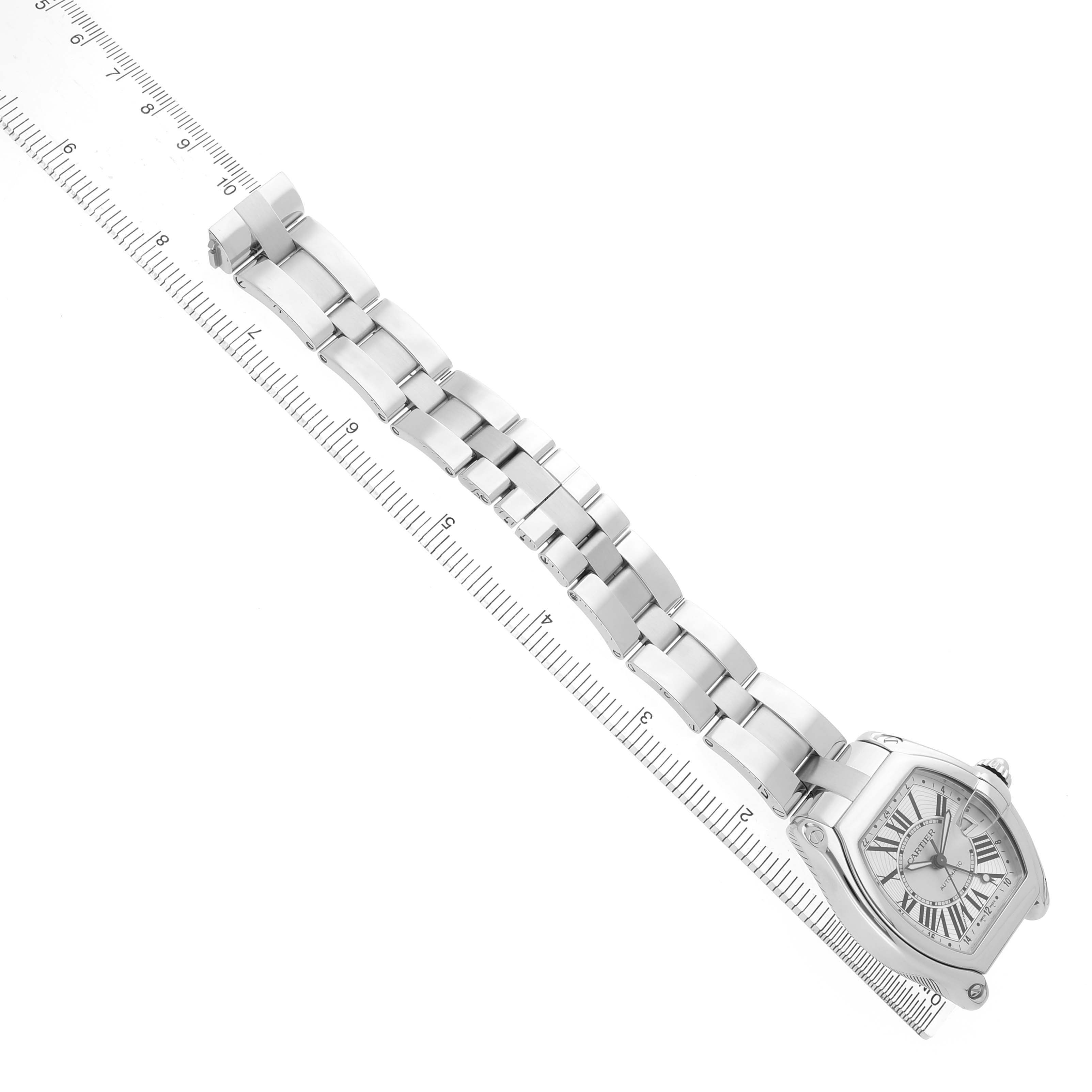 The Cartier Roadster W62032X6 Men's Stainless Steel Silver Dial watch is shown from a top-down angle, highlighting the face, case, and metal bracelet.