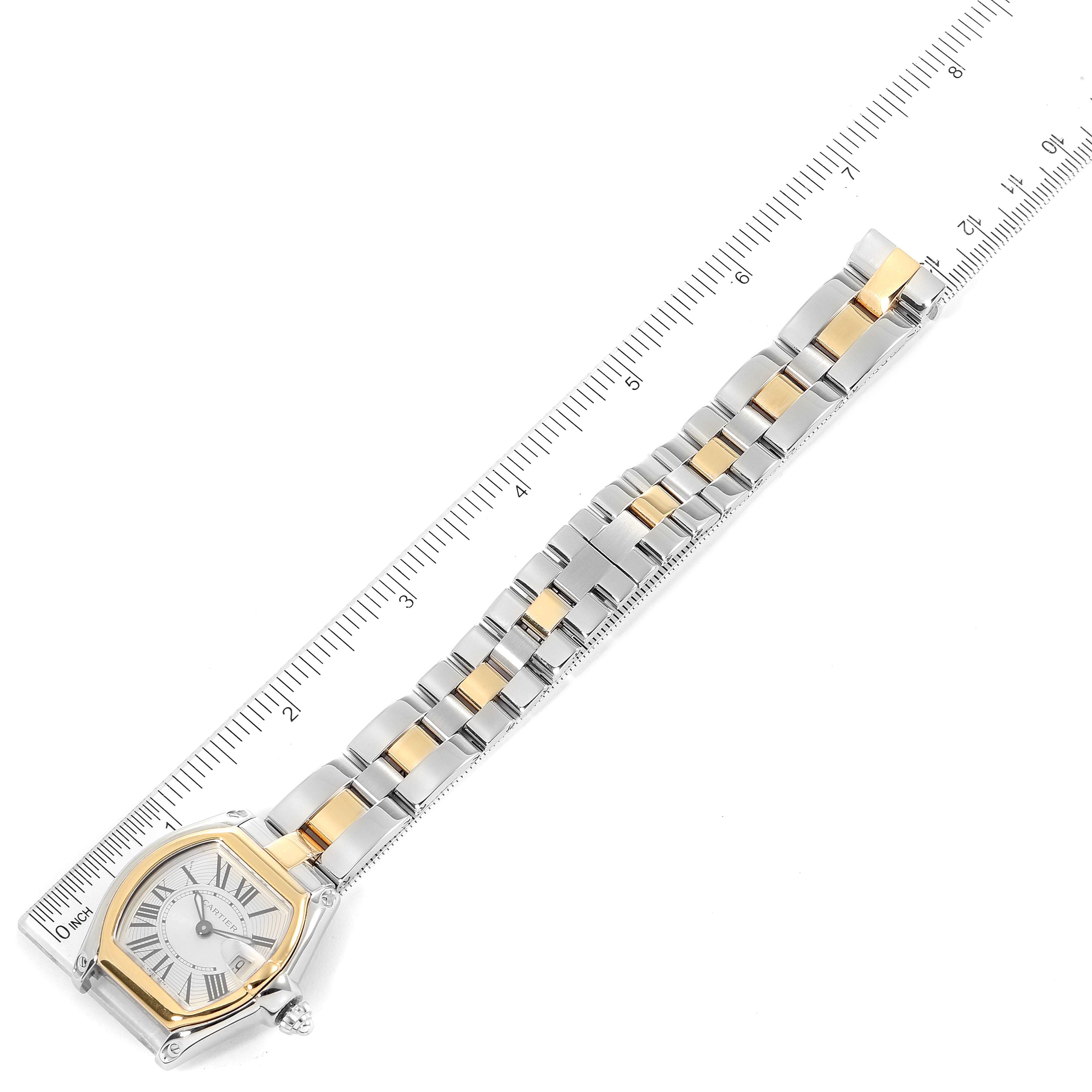 This image shows a top-down view of a Cartier Roadster W62026Y4 Women's Steel and Gold (two tone) Silver Dial W62026Y4 Women's Steel and Gold (two tone) Silver Dial watch, highlighting its full length, dial, and bracelet with a ruler for scale.