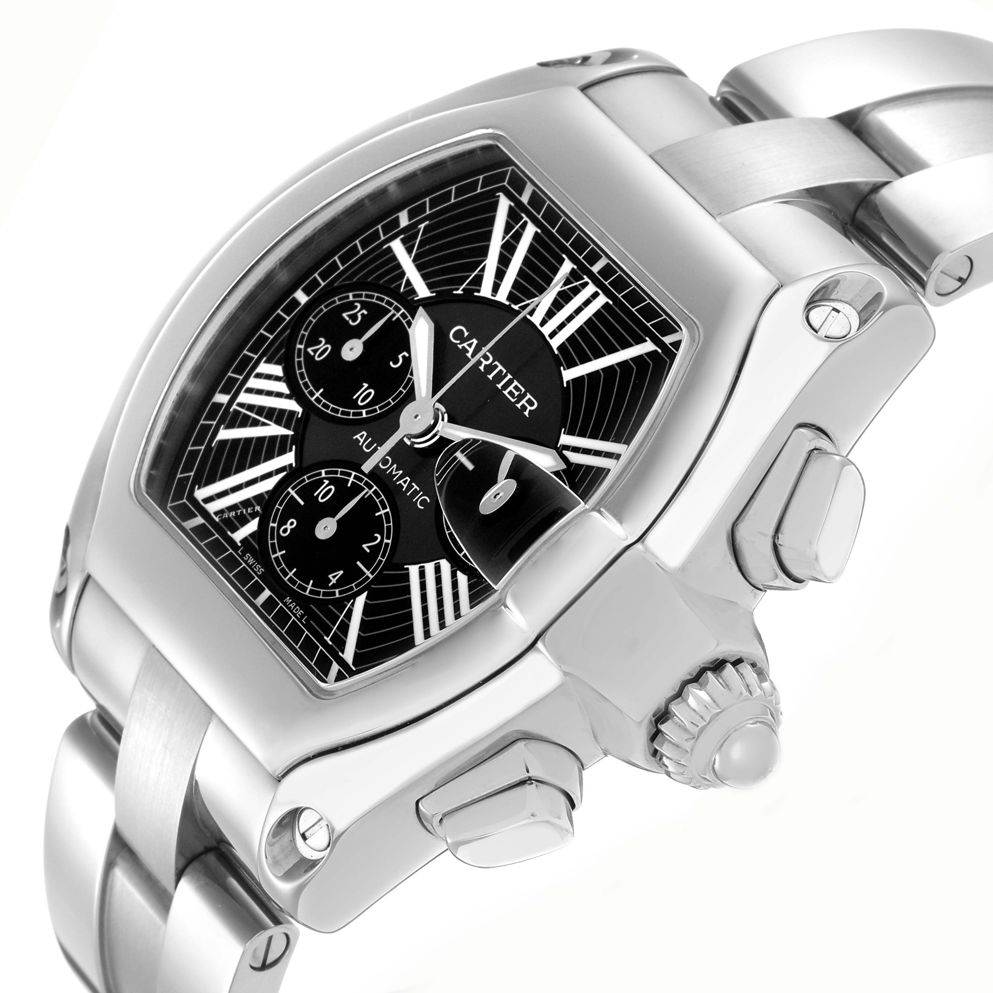 The Cartier Roadster model W62020X6 is shown from an angled side view highlighting the black dial, chronograph sub-dials, crown, and stainless steel bracelet.