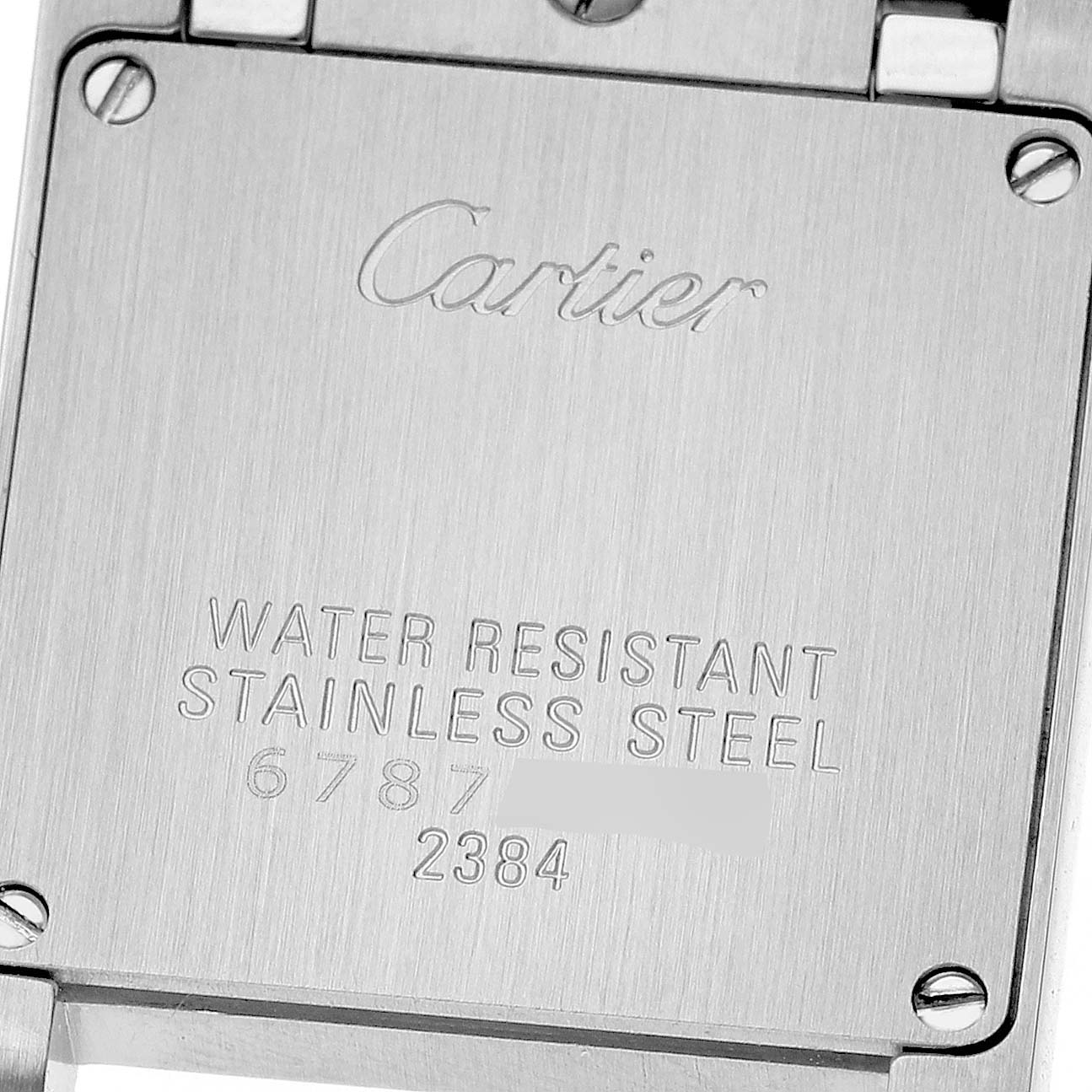 The image shows the case back of a Cartier Tank Française watch, displaying engravings and screws.