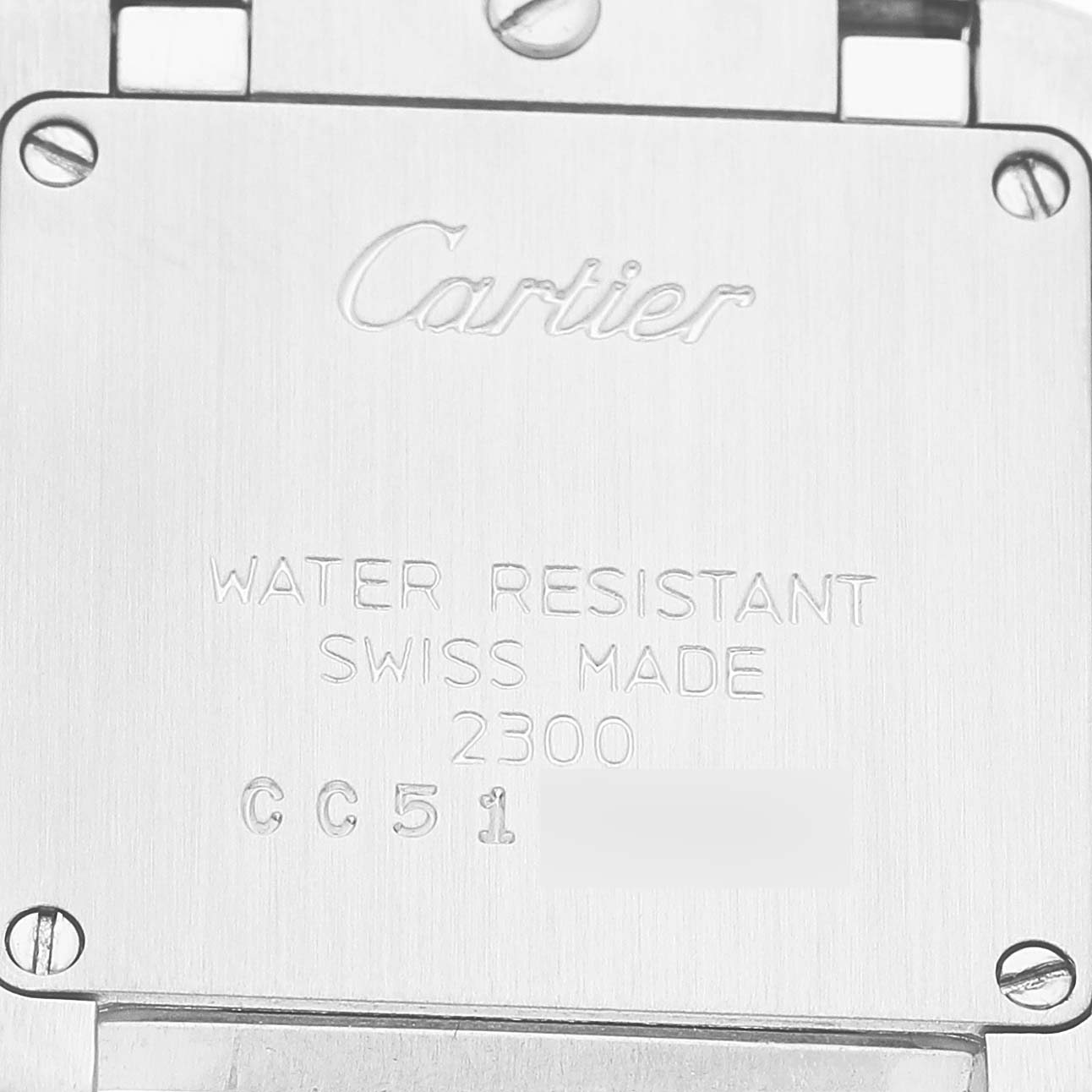 The image shows the back panel of a Cartier Tank Francaise W51007Q4 Women's Stainless Steel Silver Dial, featuring engraved branding and specifications.