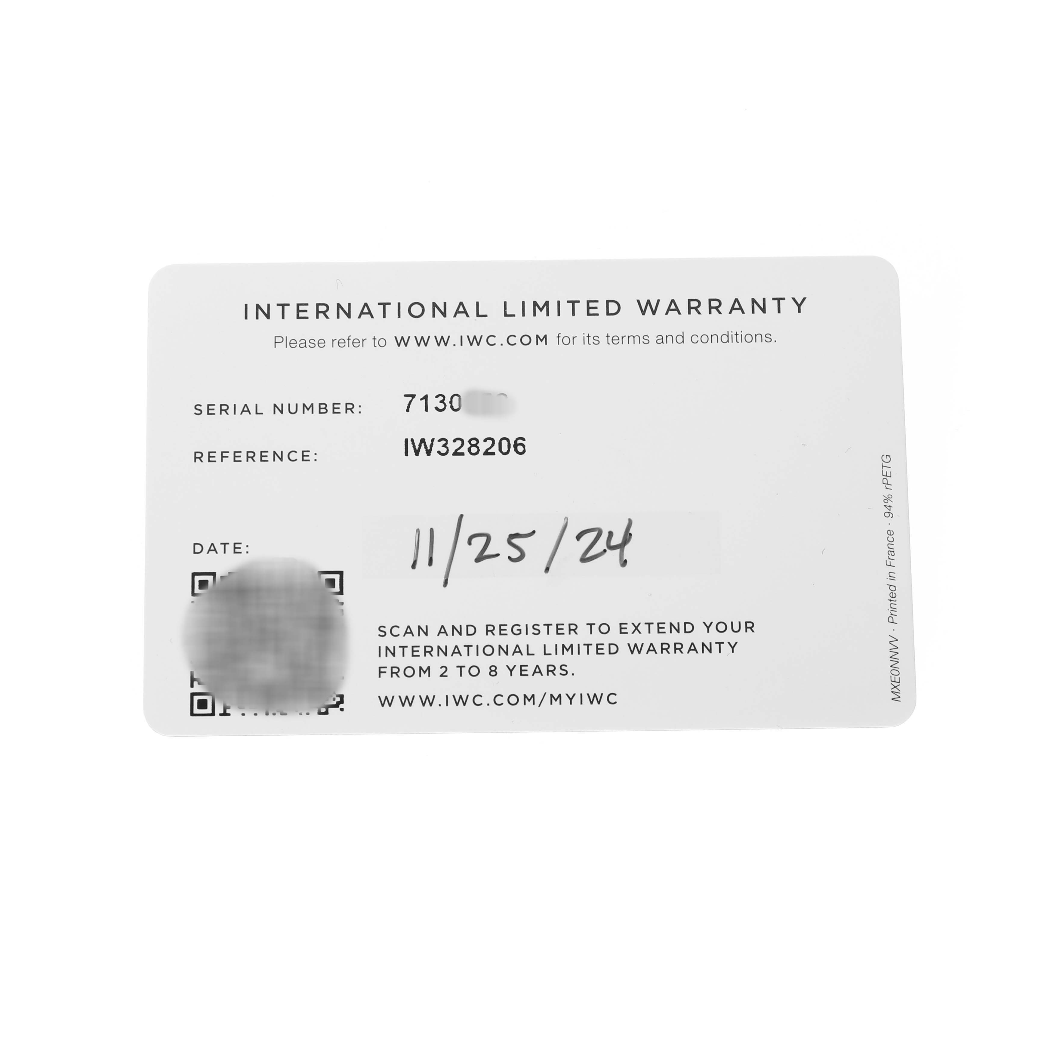 The image shows an IWC Pilot IW328206 Men's Stainless Steel Green Dial model's international limited warranty card from a top-down angle.