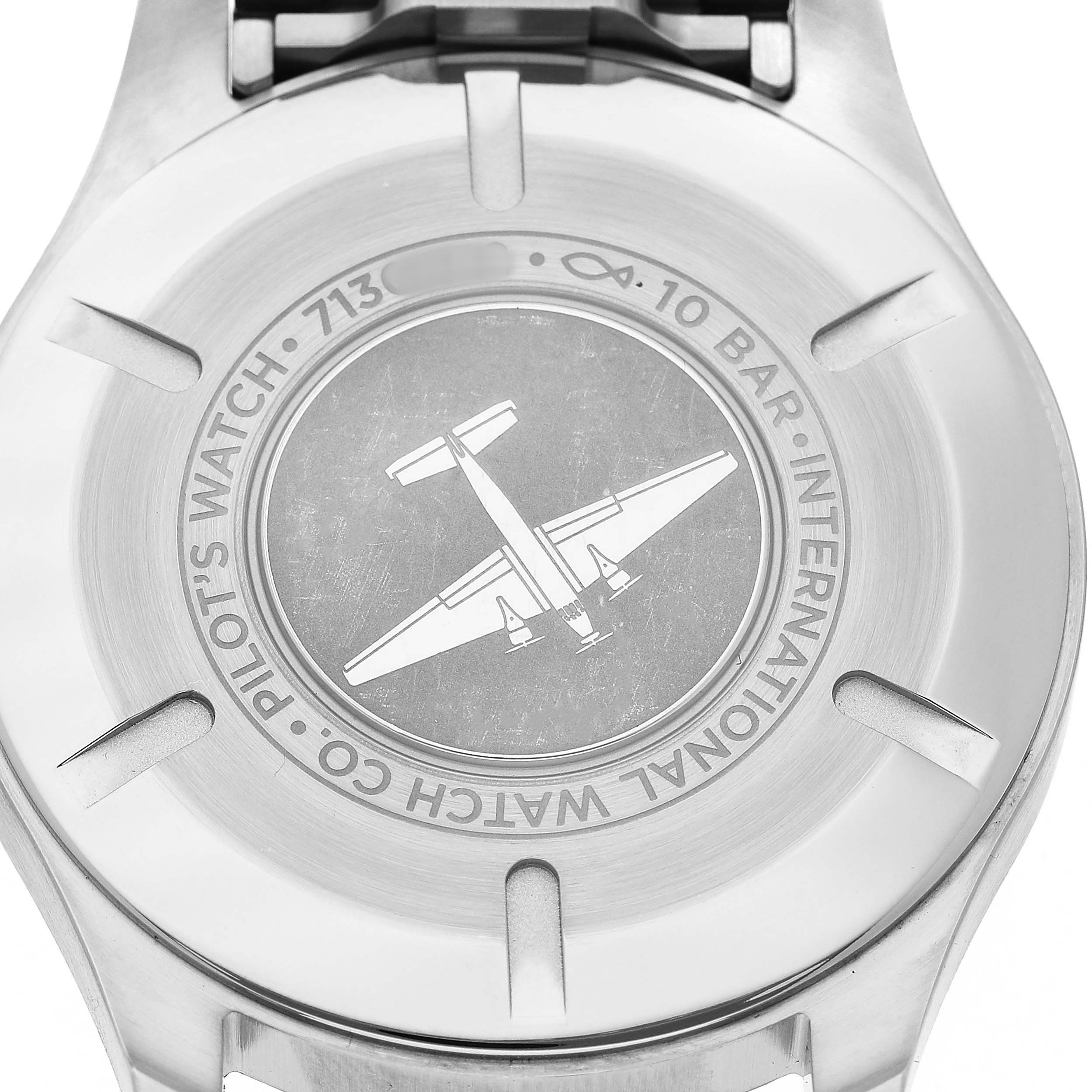 The image shows the back case of an IWC Pilot IW328206 Men's Stainless Steel Green Dial model watch, featuring an airplane engraving and branding details.