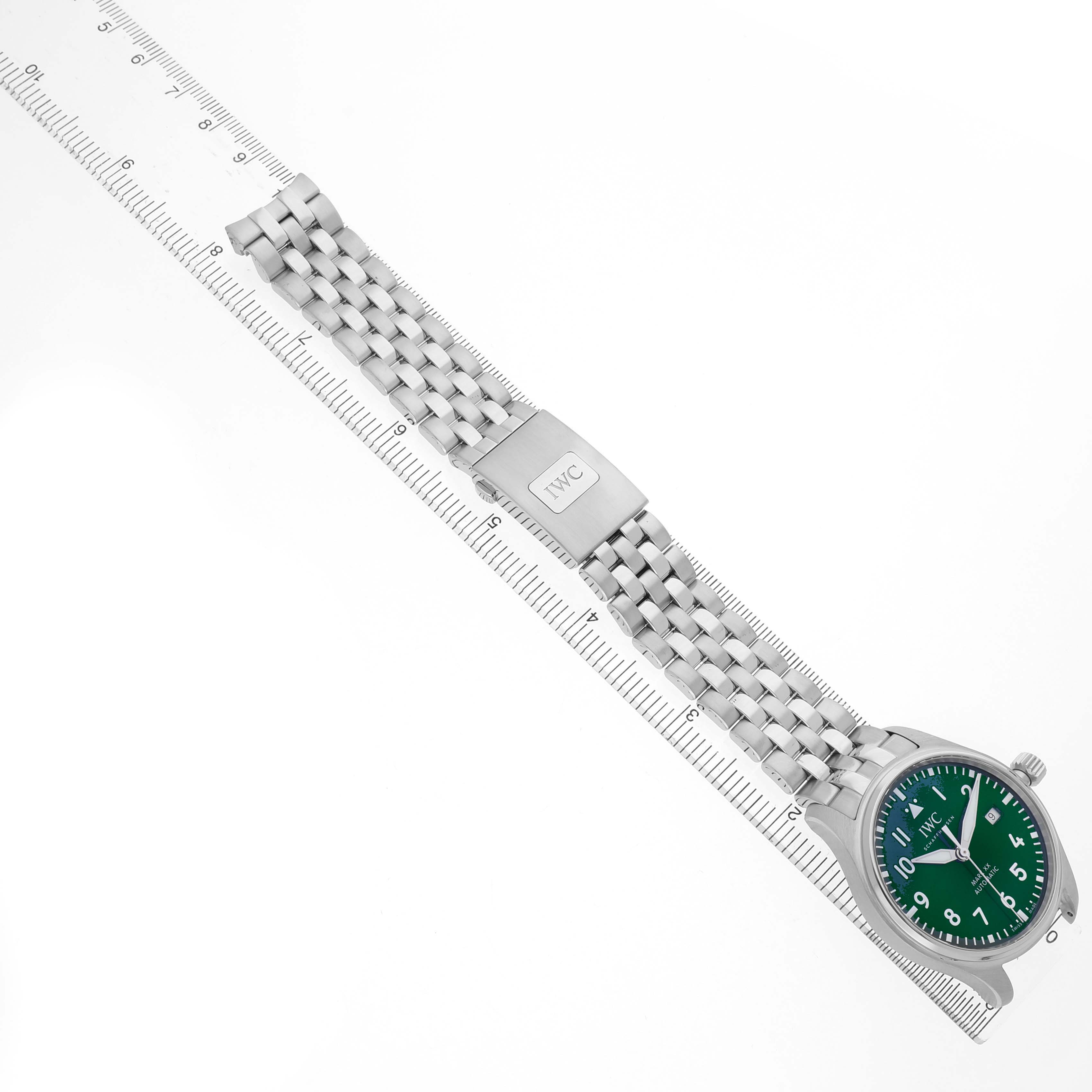The image shows an IWC Pilot IW328206 Men's Stainless Steel Green Dial watch from a top angle, highlighting the bracelet, clasp, and green dial.