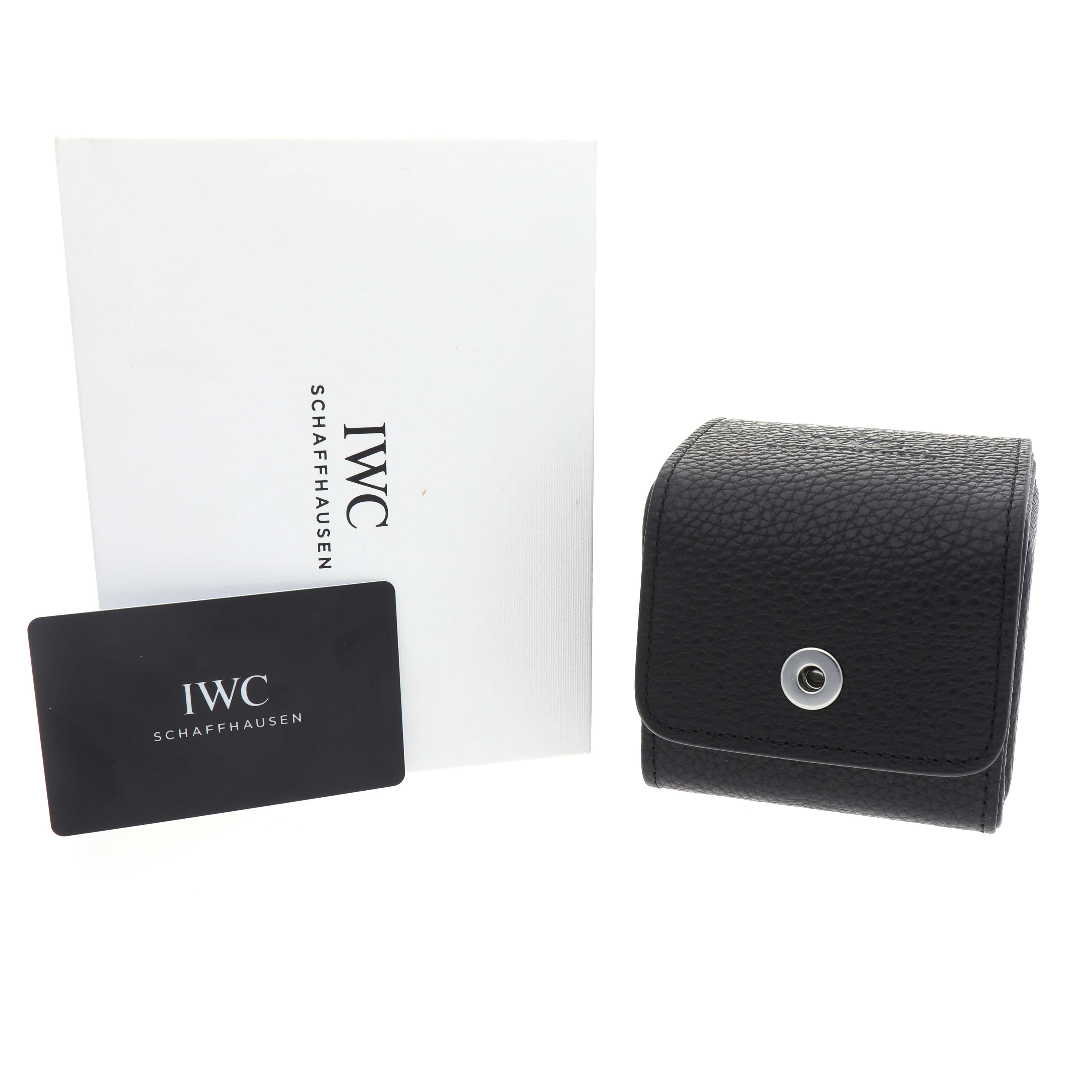 The image shows a leather case, warranty card, and booklet for the IWC Pilot IW328206 Men's Stainless Steel Green Dial model.