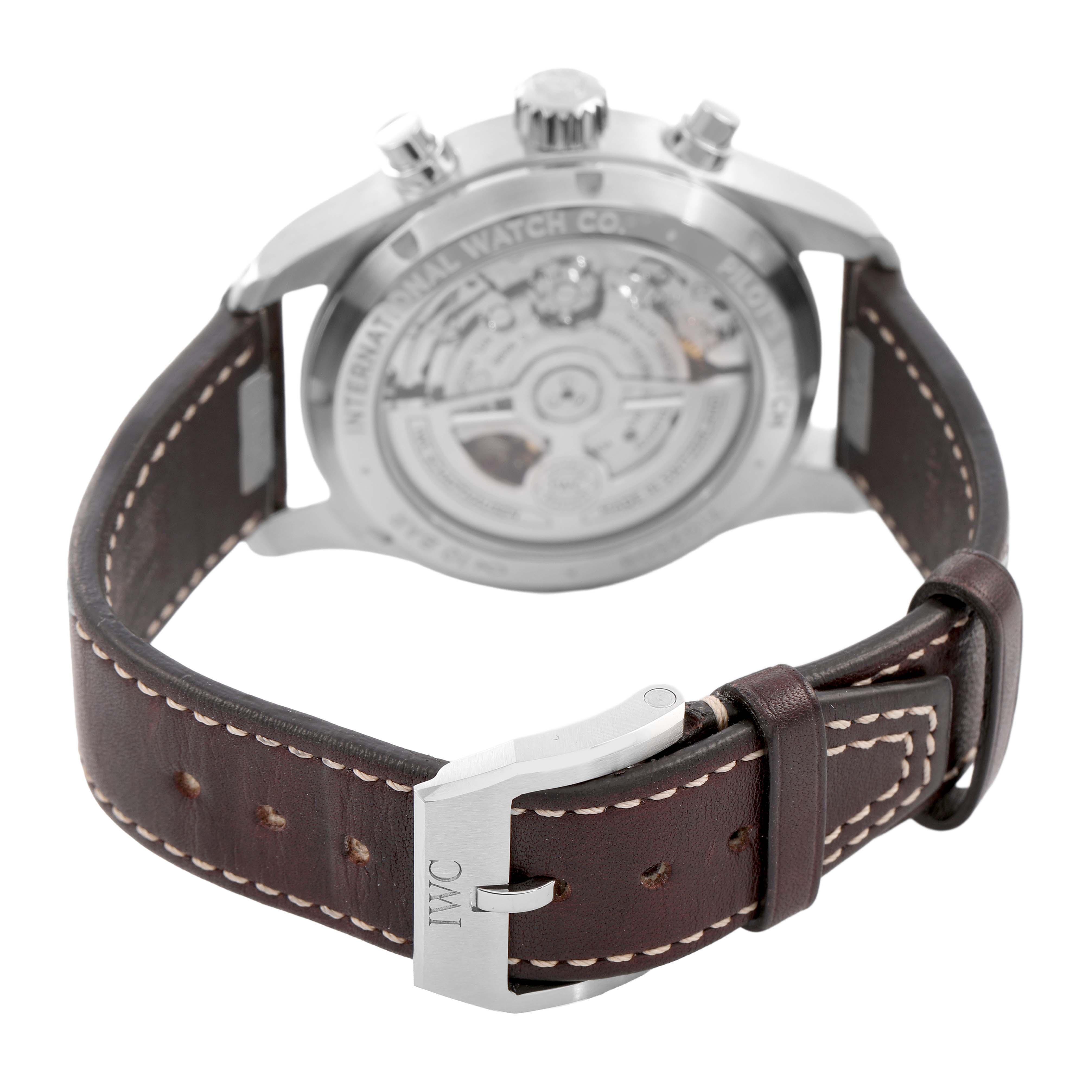 The image shows the back view of the IWC Pilot IW388103 Men's Stainless Steel Green Dial model watch, highlighting the case back and brown leather strap with a buckle.
