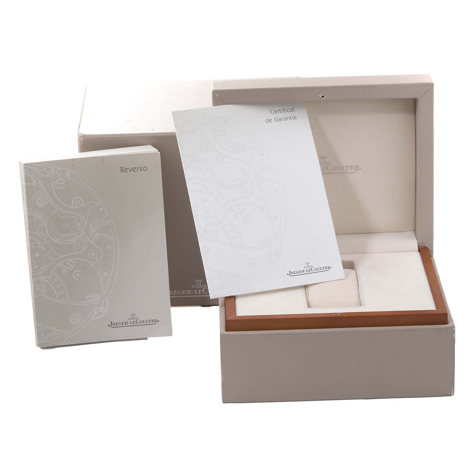 This image shows the Jaeger-LeCoultre Reverso set with the watch box, instruction booklet, and guarantee certificate.
