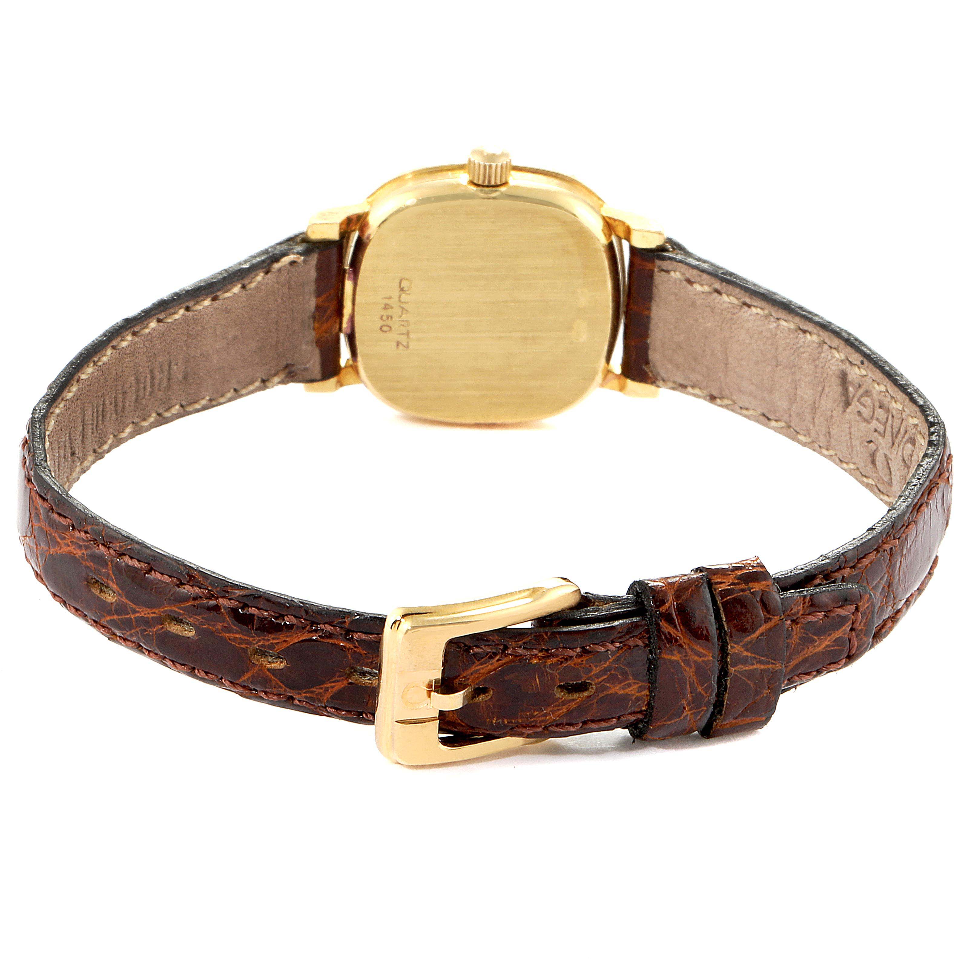 The image shows the back view of an Omega 1450 Women's Yellow Gold Silver Dial 1450 Women's Yellow Gold Silver Dial DeVille Mini Yellow Gold Diamond Cocktail Ladies Watch 1450, highlighting the case, crown, and leather strap.