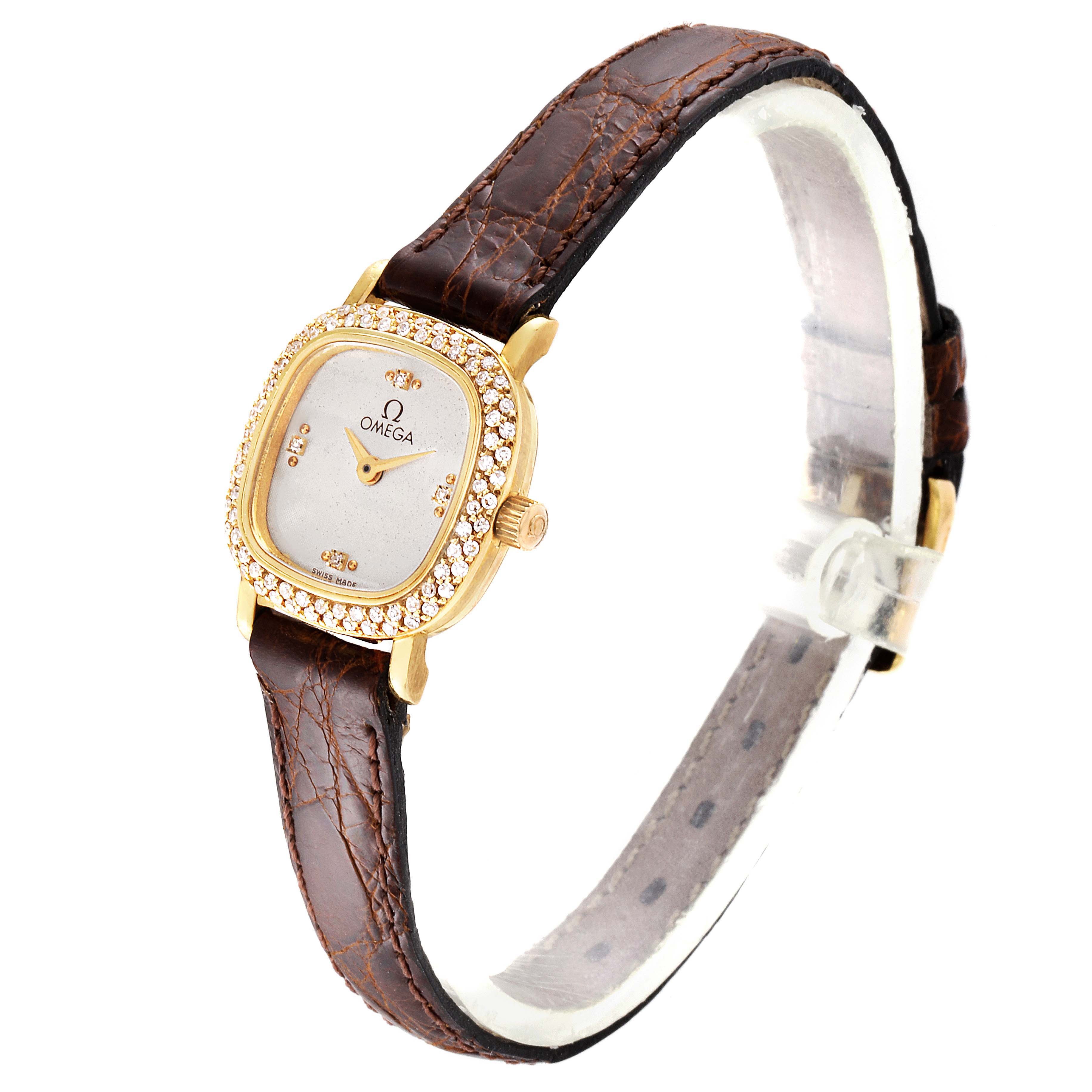 The image shows an angled view of the Omega 1450 Women's Yellow Gold Silver Dial 1450 Women's Yellow Gold Silver Dial DeVille Mini Yellow Gold Diamond Cocktail Ladies Watch 1450, featuring the face, bezel, and leather strap.