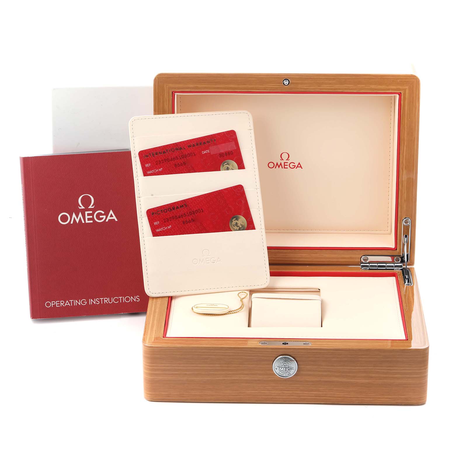 The image shows the packaging and accessories for the Omega Planet Ocean, model 232.90.46.51.03.001, including the box, instruction manual, and warranty cards.