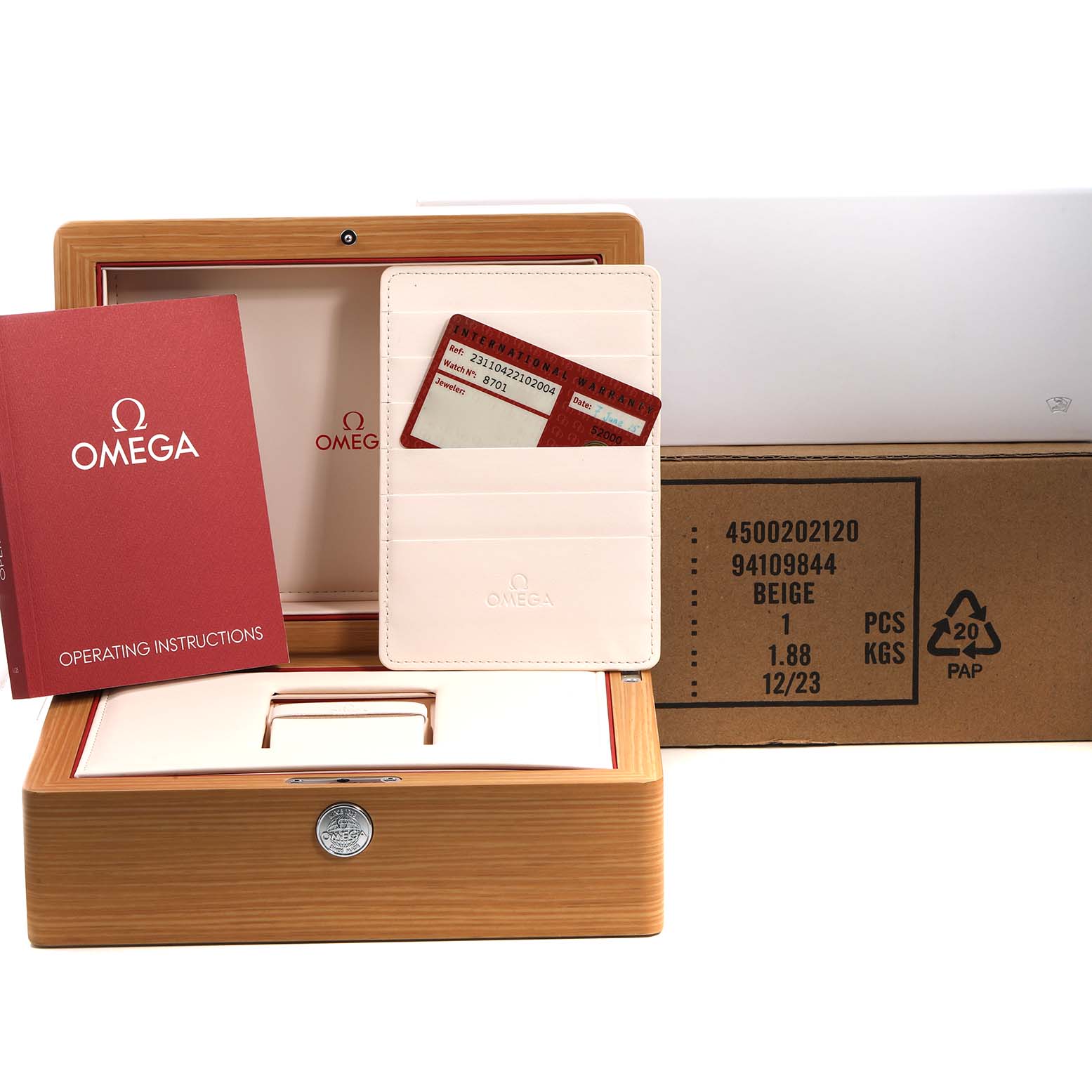 The image shows the packaging and accessories for an Omega Seamaster 231.10.42.21.02.004 Men's Stainless Steel Silver Dial, including the box, operating instructions, and warranty card.