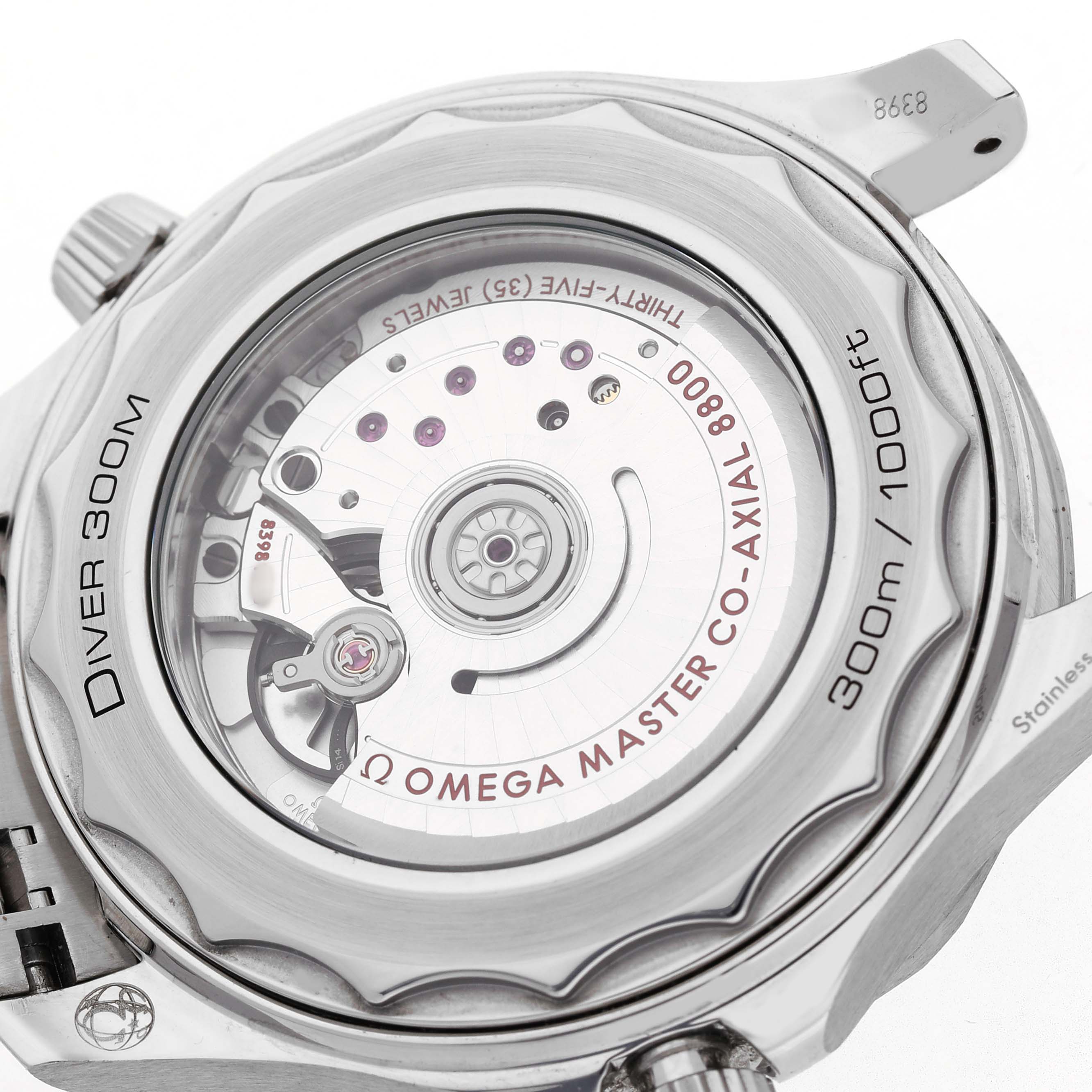 The image shows the case back of an Omega Seamaster 210.32.42.20.10.001 Men's Stainless Steel Green Dial, revealing its Co-Axial movement and "Diver 300M" engraving.