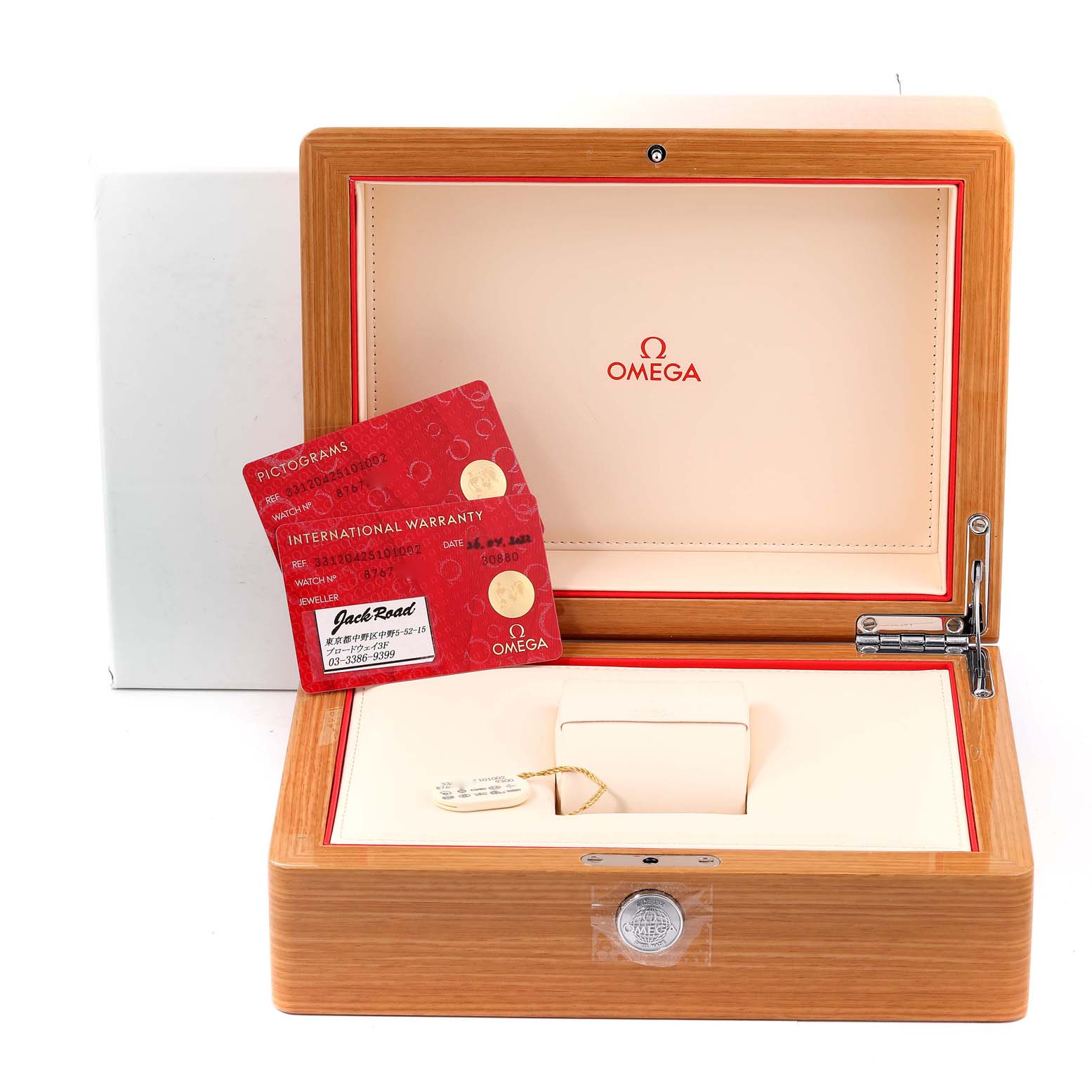 This image shows an Omega Speedmaster 331.20.42.51.01.002 Men's Steel and Gold (two tone) Black Dial 331.20.42.51.01.002 Men's Steel and Gold (two tone) Black Dial watch box open to display international warranty cards inside.