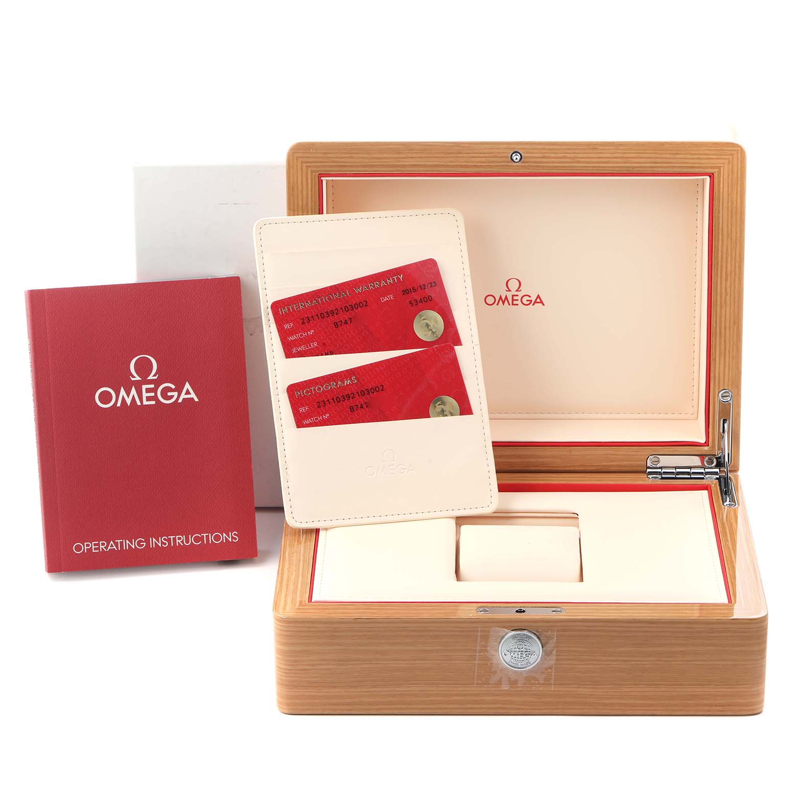 The image shows the packaging and documentation for the Omega Speedmaster model 323.30.40.40.02.001, including its box, manual, and warranty cards.