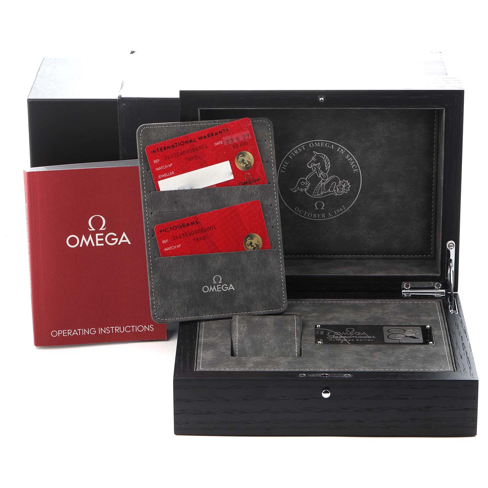 The image shows the packaging and accessories for the Omega Speedmaster model 311.32.40.30.01.001, including the box, instruction manual, and warranty cards.