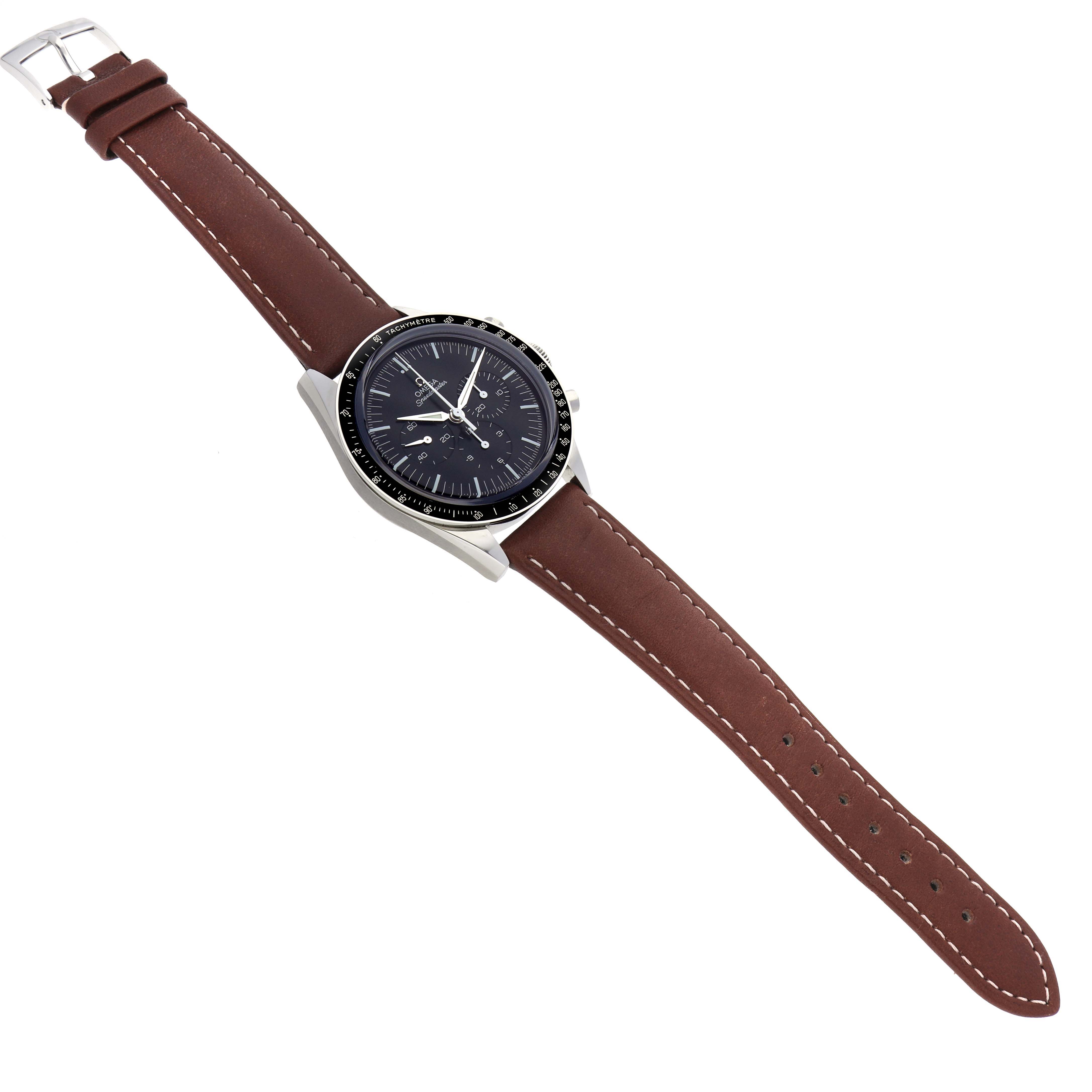The Omega Speedmaster model 311.32.40.30.01.001 is shown from a top-down angle, displaying its full face and brown leather strap with a clasp.