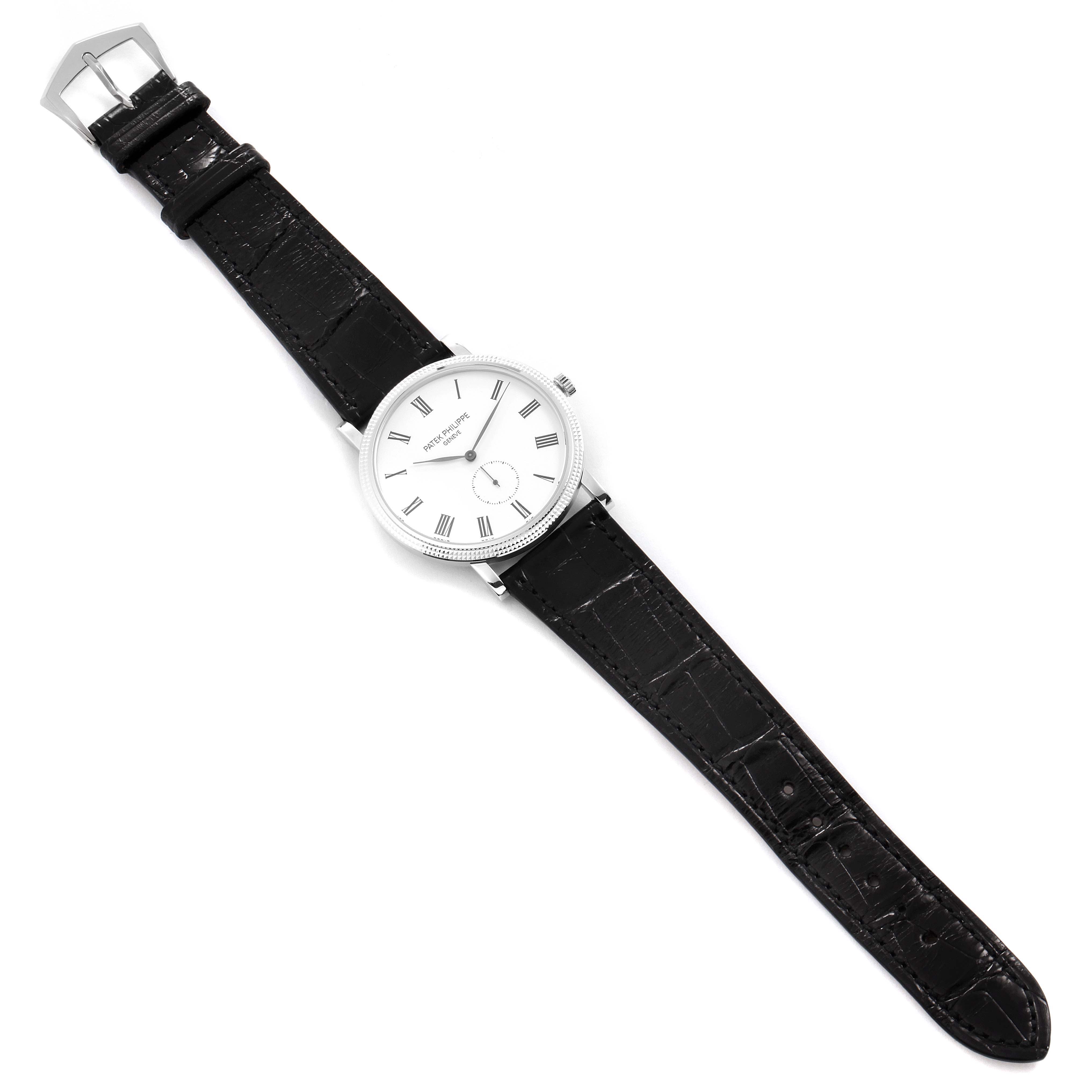 The Patek Philippe Calatrava 5119G Men's White Gold White Dial 5119G Men's White Gold White Dial watch is shown from a top-down angle, displaying the watch face and black leather strap.