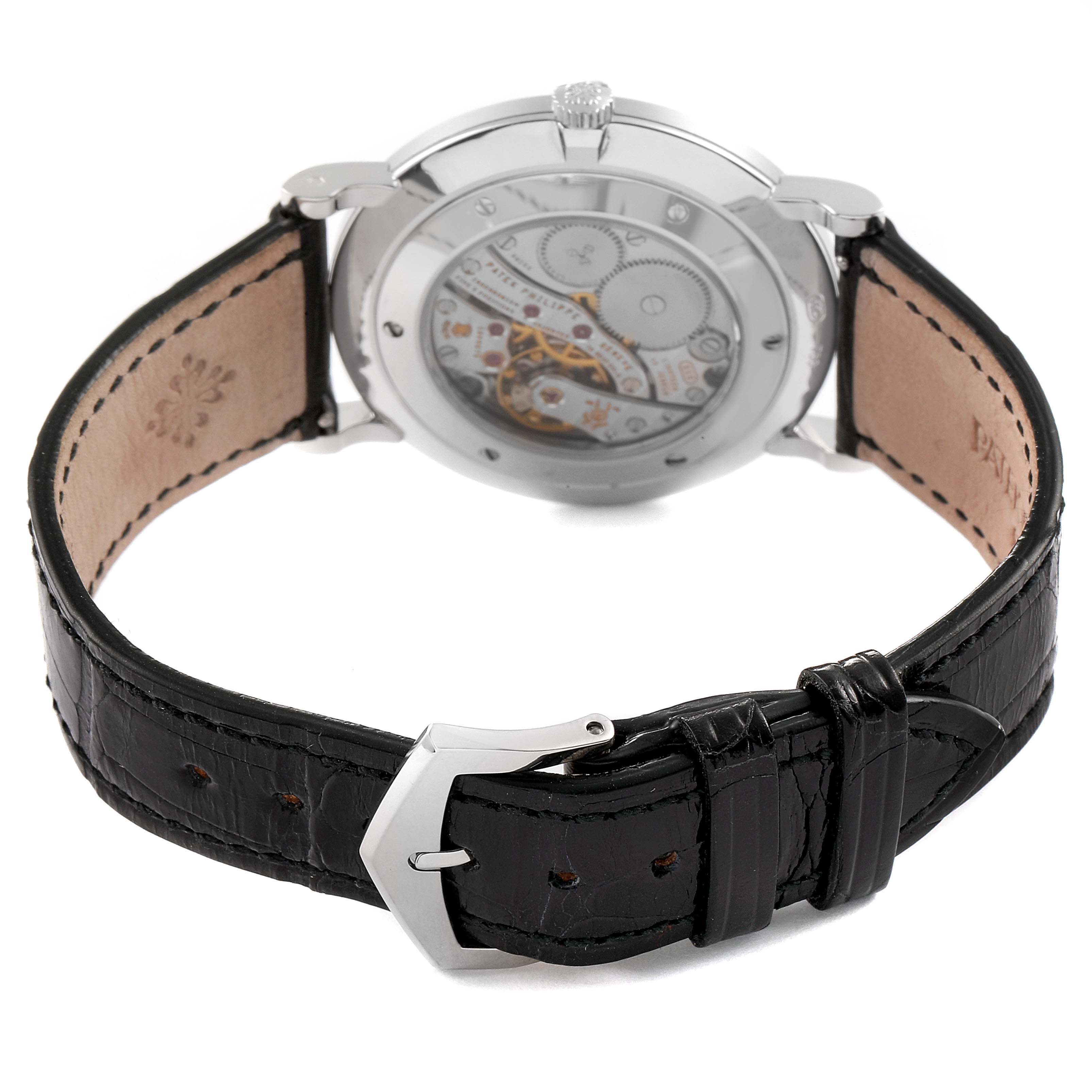 This image shows the back view of a Patek Philippe Calatrava 5119G Men's White Gold White Dial 5119G Men's White Gold White Dial watch, highlighting its mechanical movement and black leather strap.